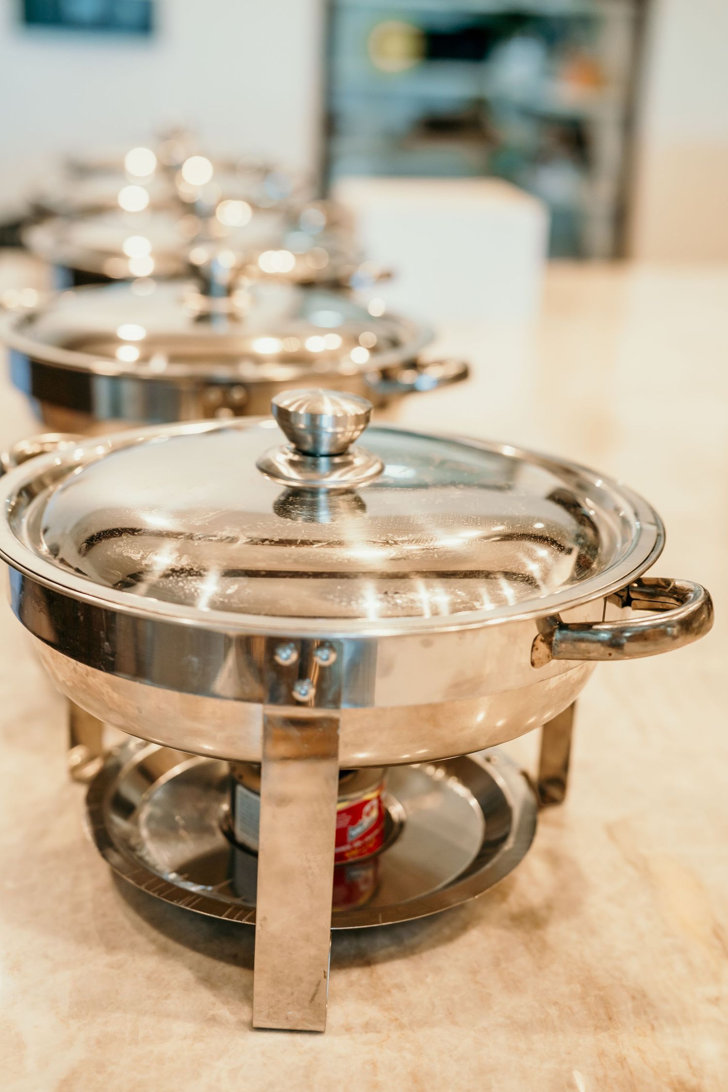 Stainless steel chafing dish with lid lined up for catering service. Session in Anthem Arizona
