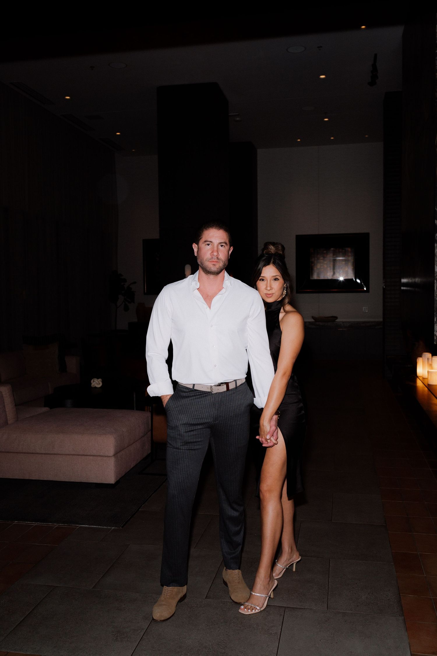Couple dancing intimately in a dimly lit room during an evening celebration.