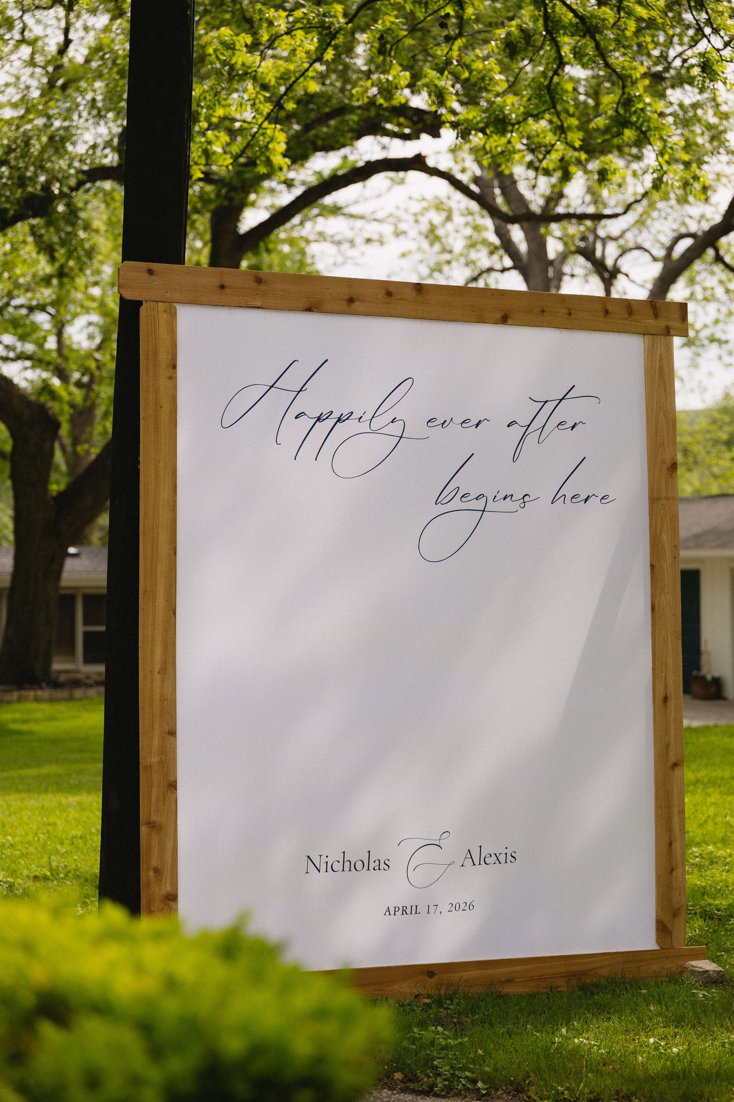 Outdoor wedding sign reading Happily Ever After Begins Here for Nicholas and Alexis, April 27, 2020.