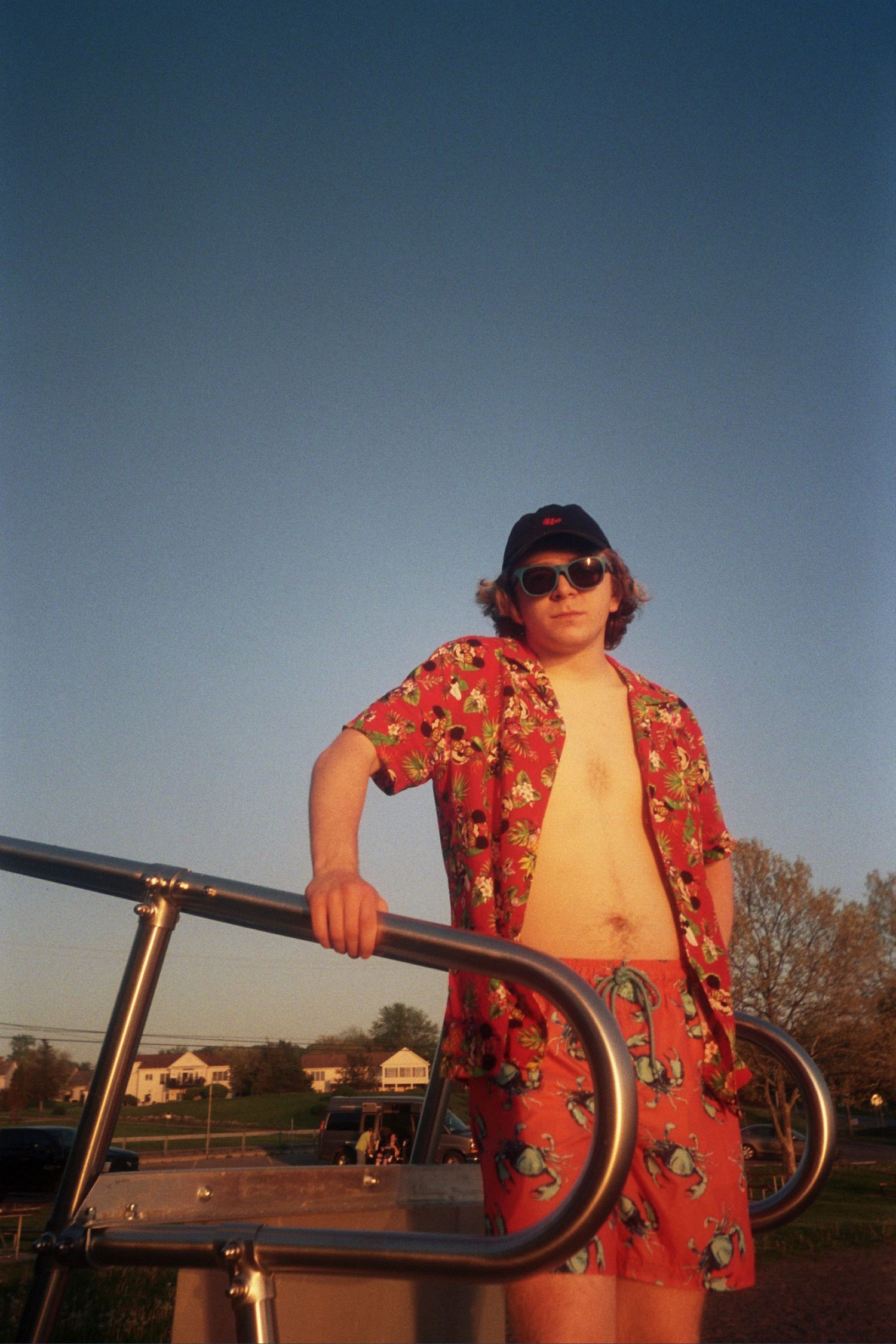 A man standing near a metal railing