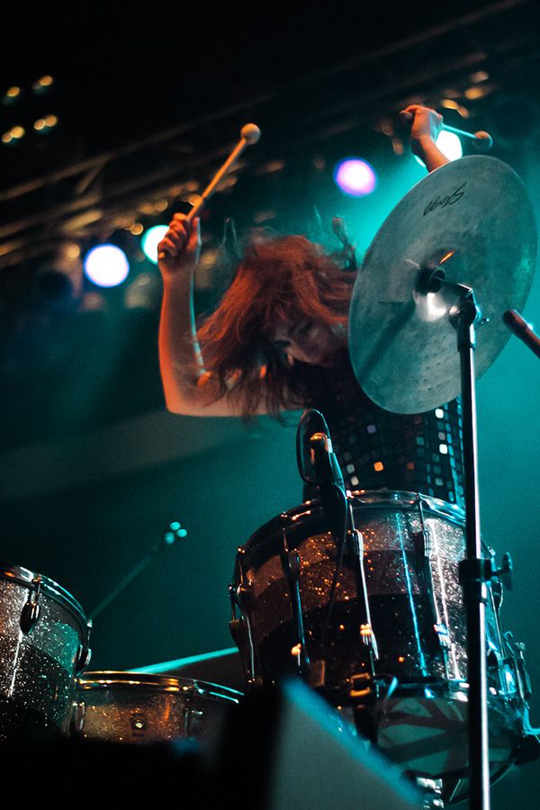 A woman playing drums