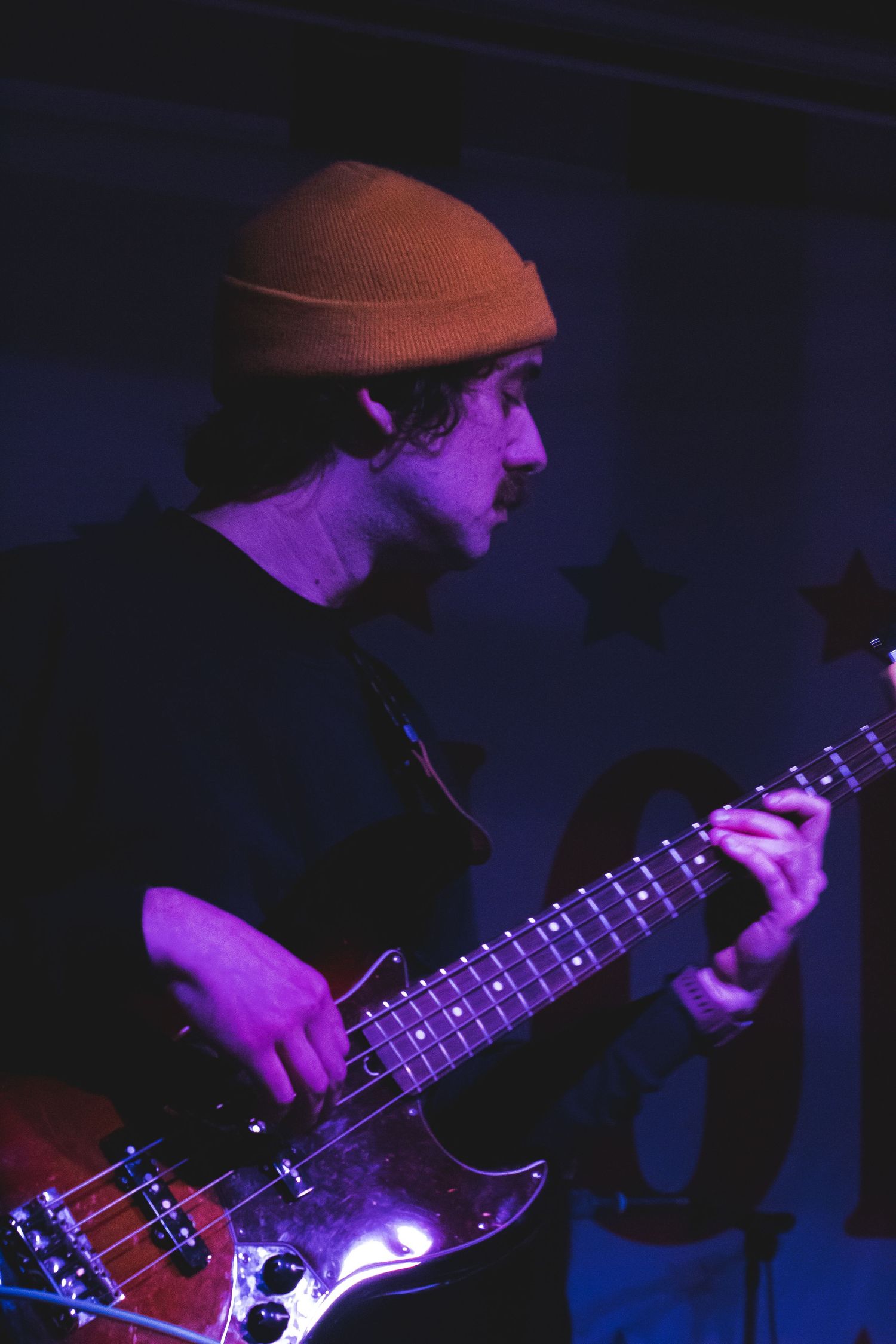 A man in a hat playing a guitar