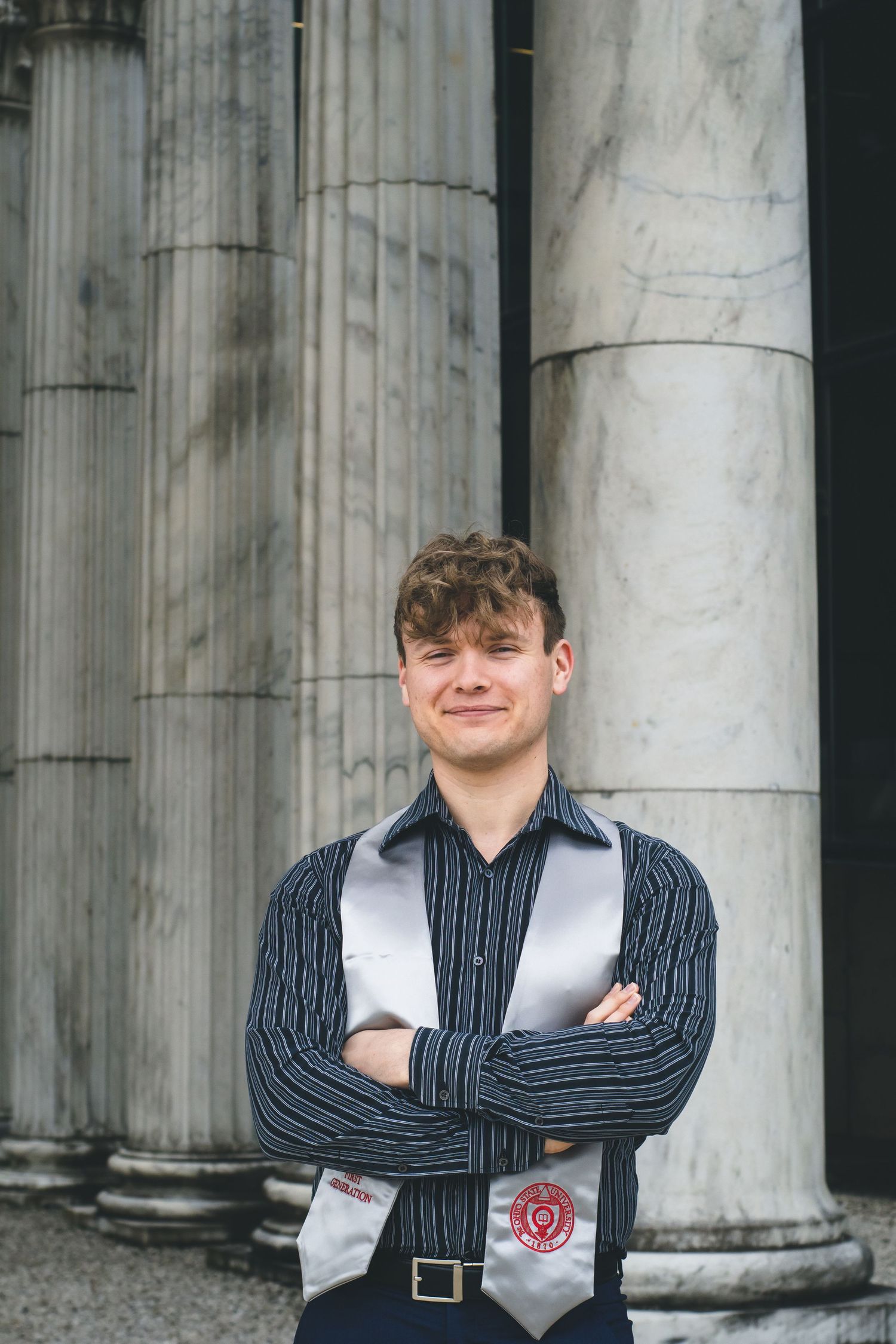 A man standing in front of a column