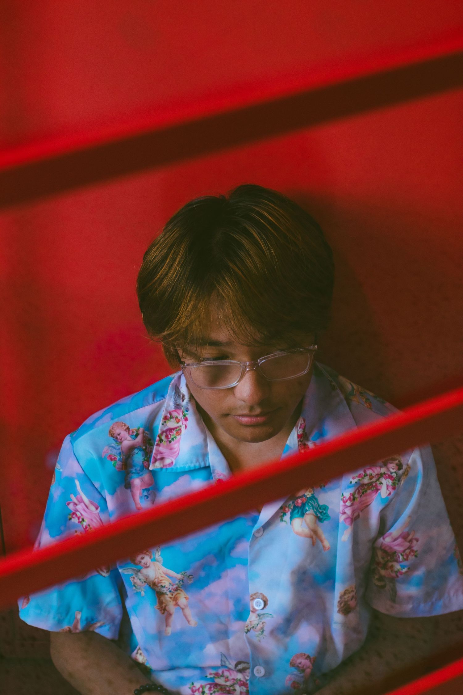 A man sitting in a red room.