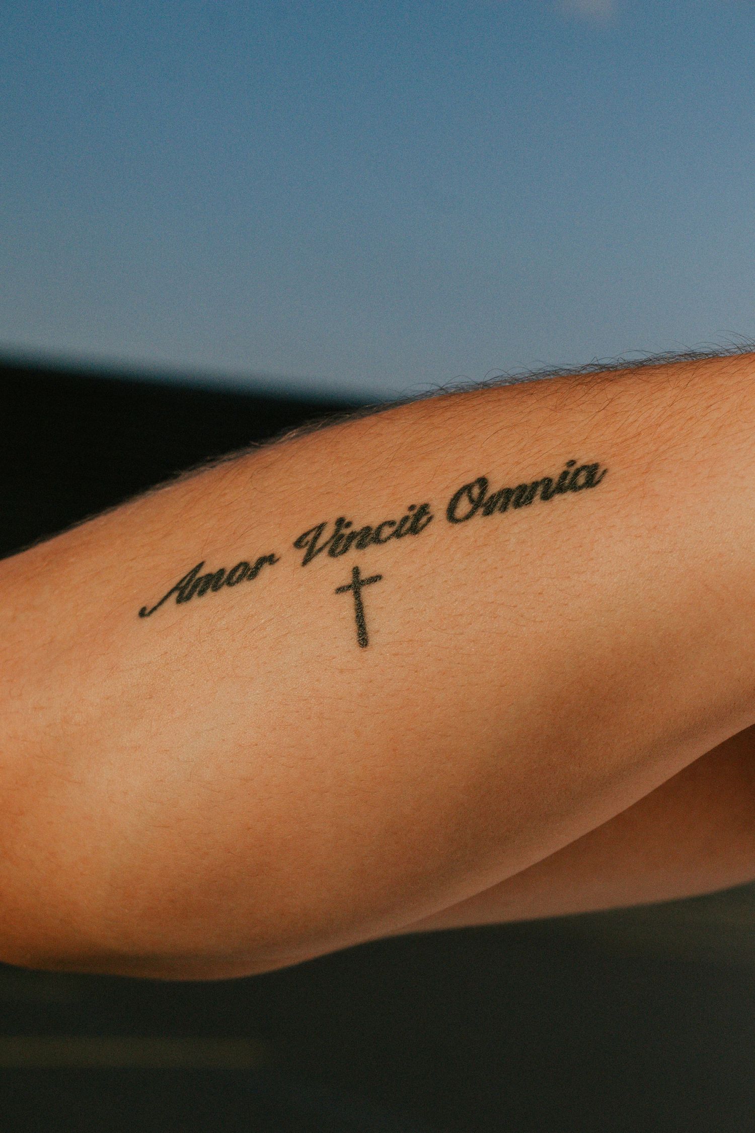 A close-up photo of a tattoo on a man's forearm.