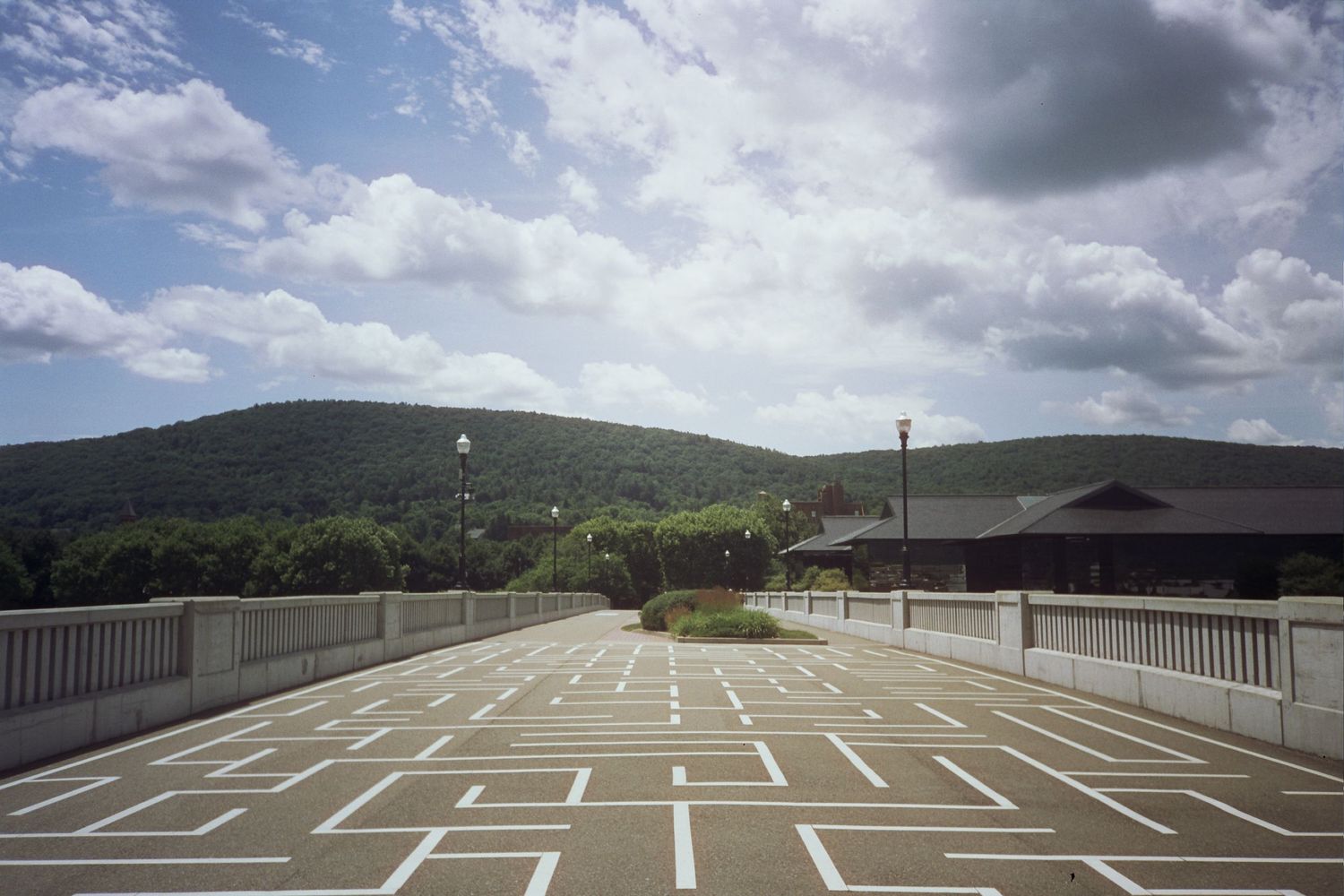 A geometric pattern on concrete under a cloudy sky
