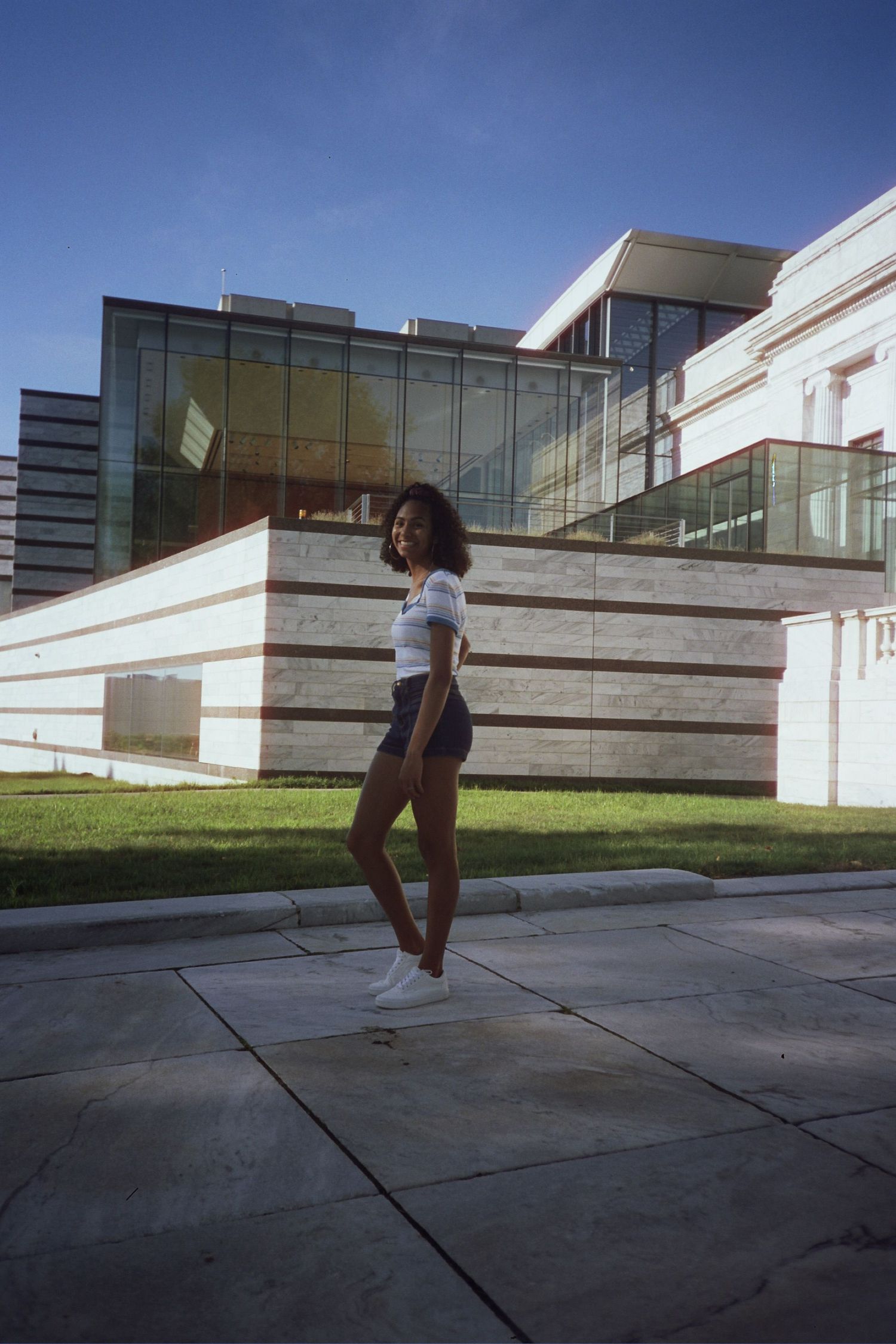 A woman standing in front of a building