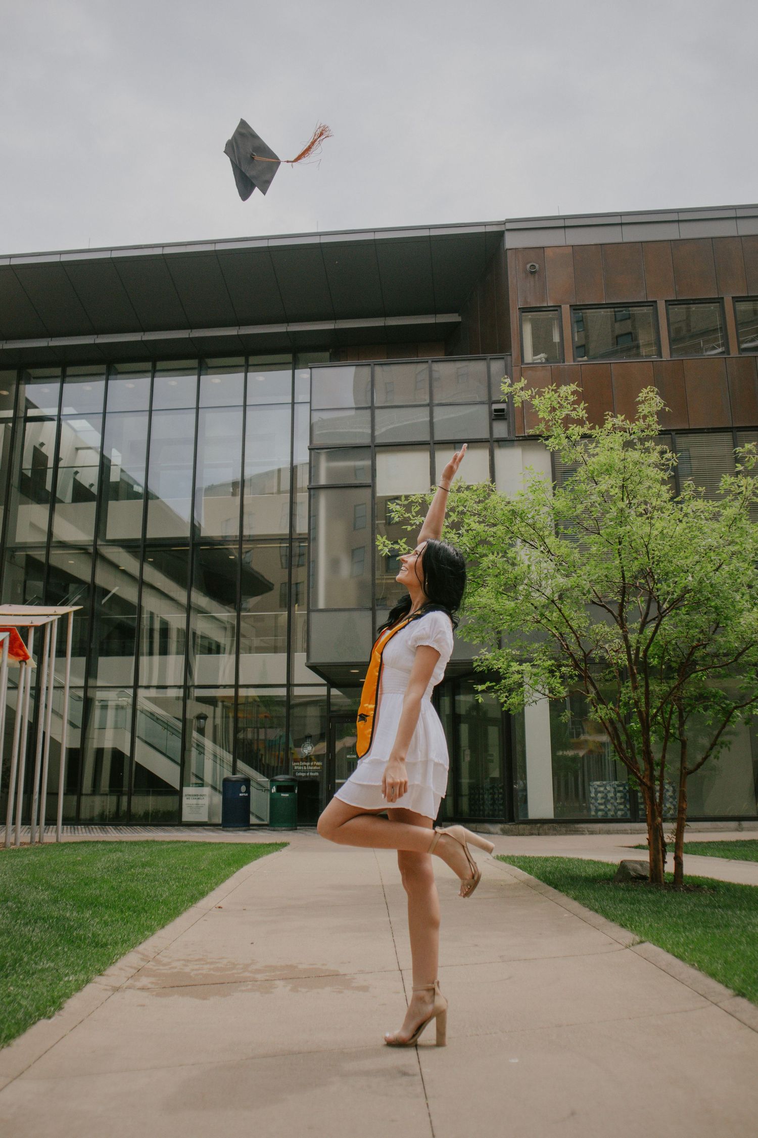 A woman throwing her cap into the air