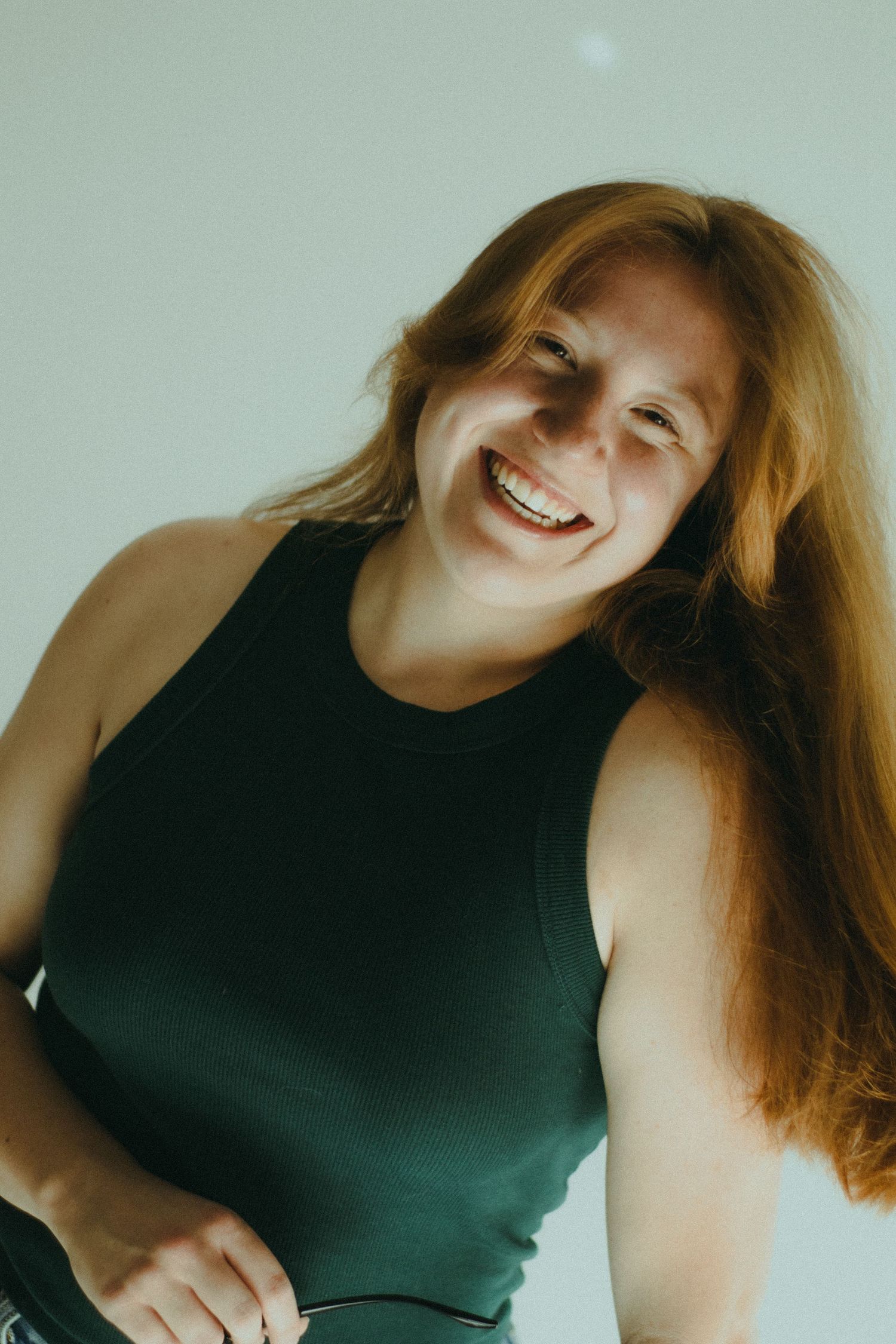 A photo of a woman in a green shirt smiling.