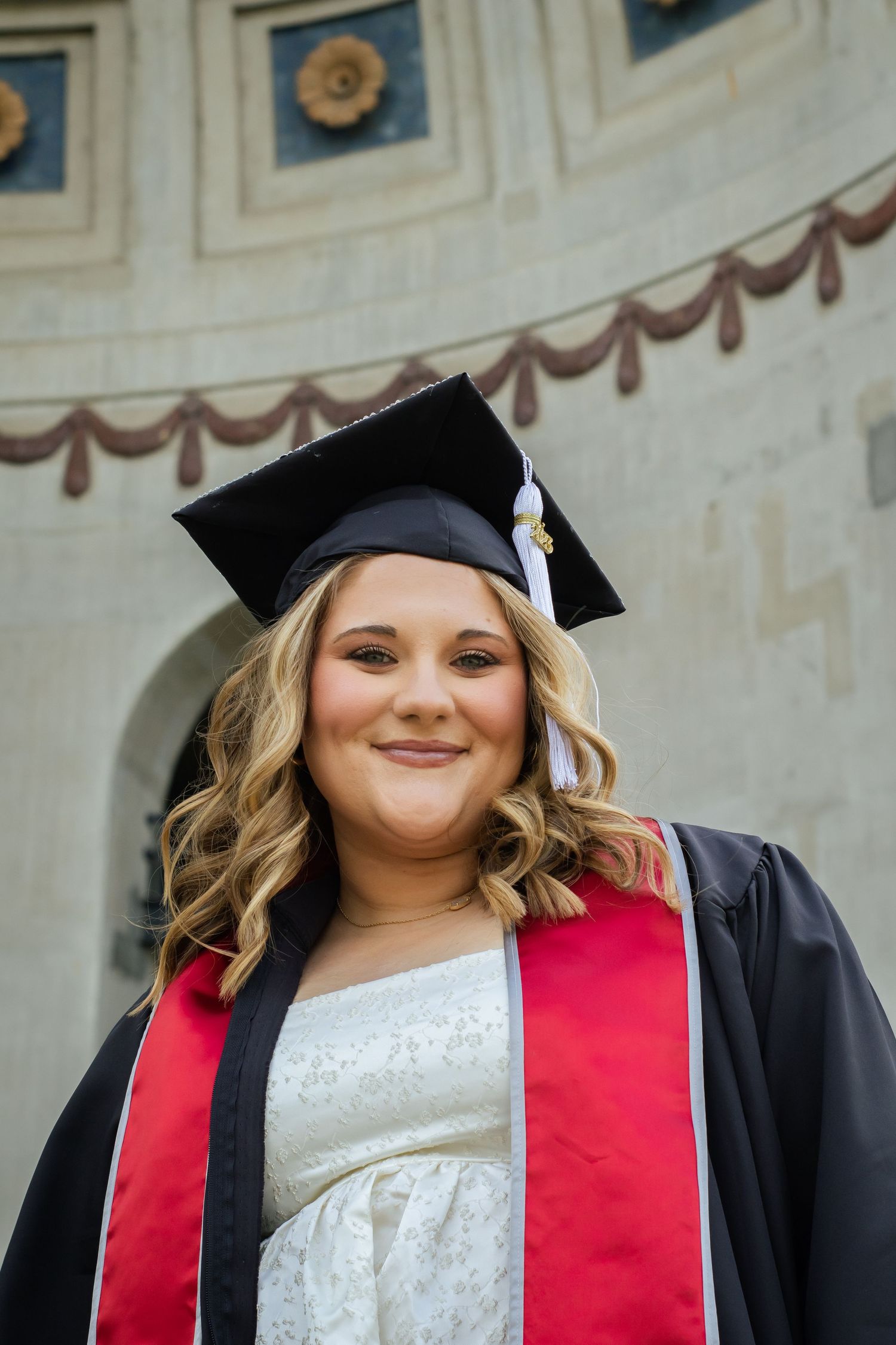 A woman wearing a cap and gown.