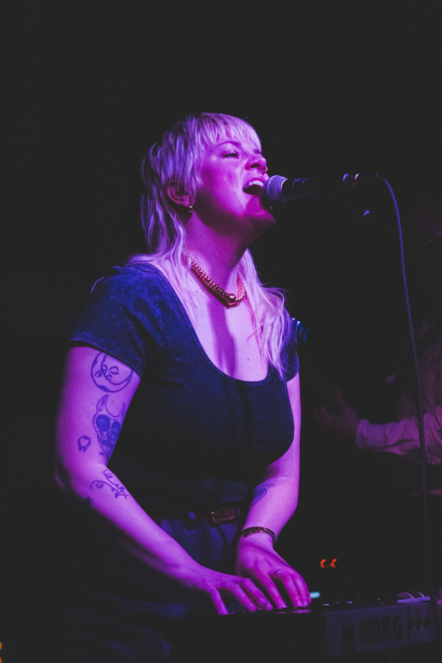 A woman singing while playing piano