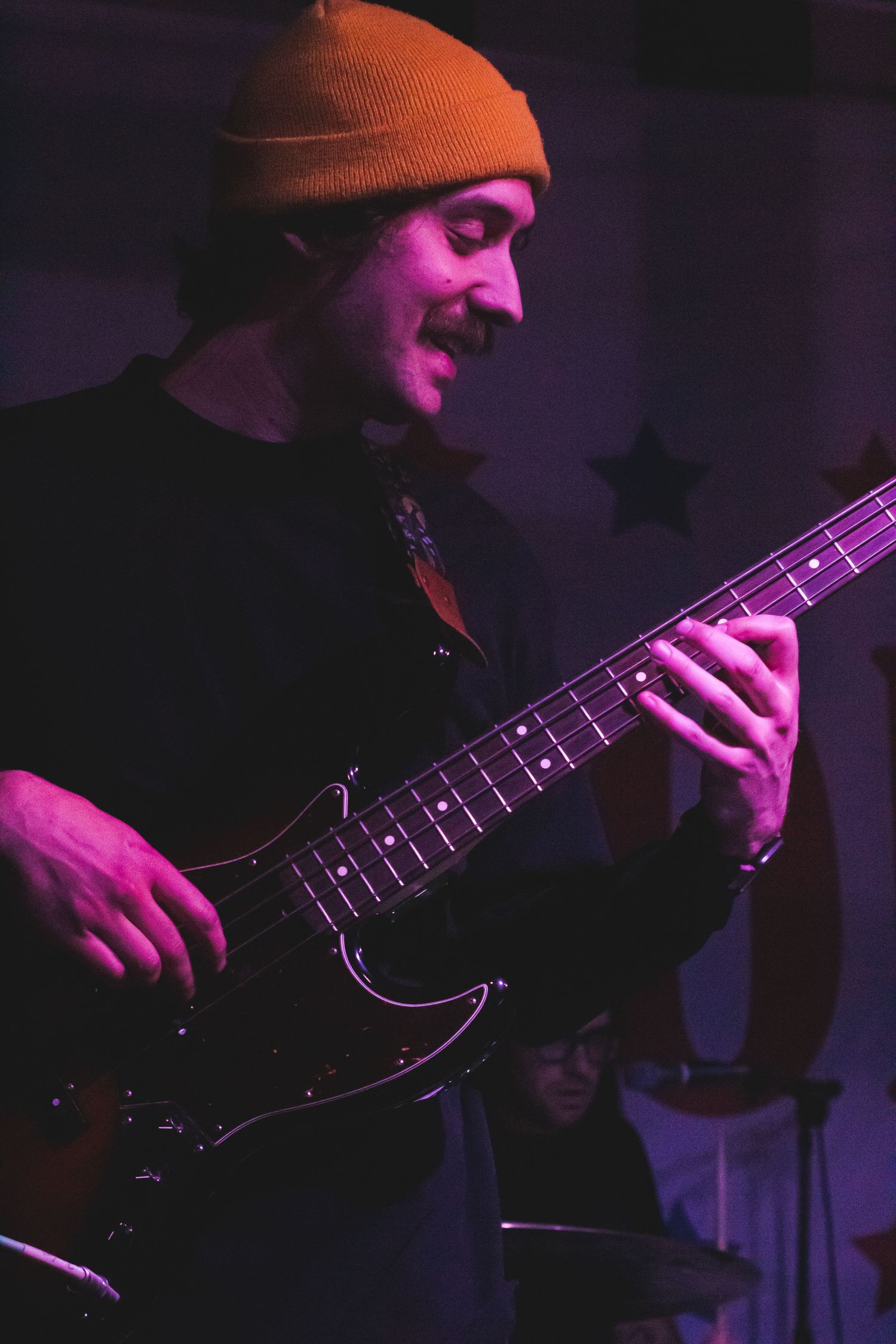 A man in a hat playing guitar