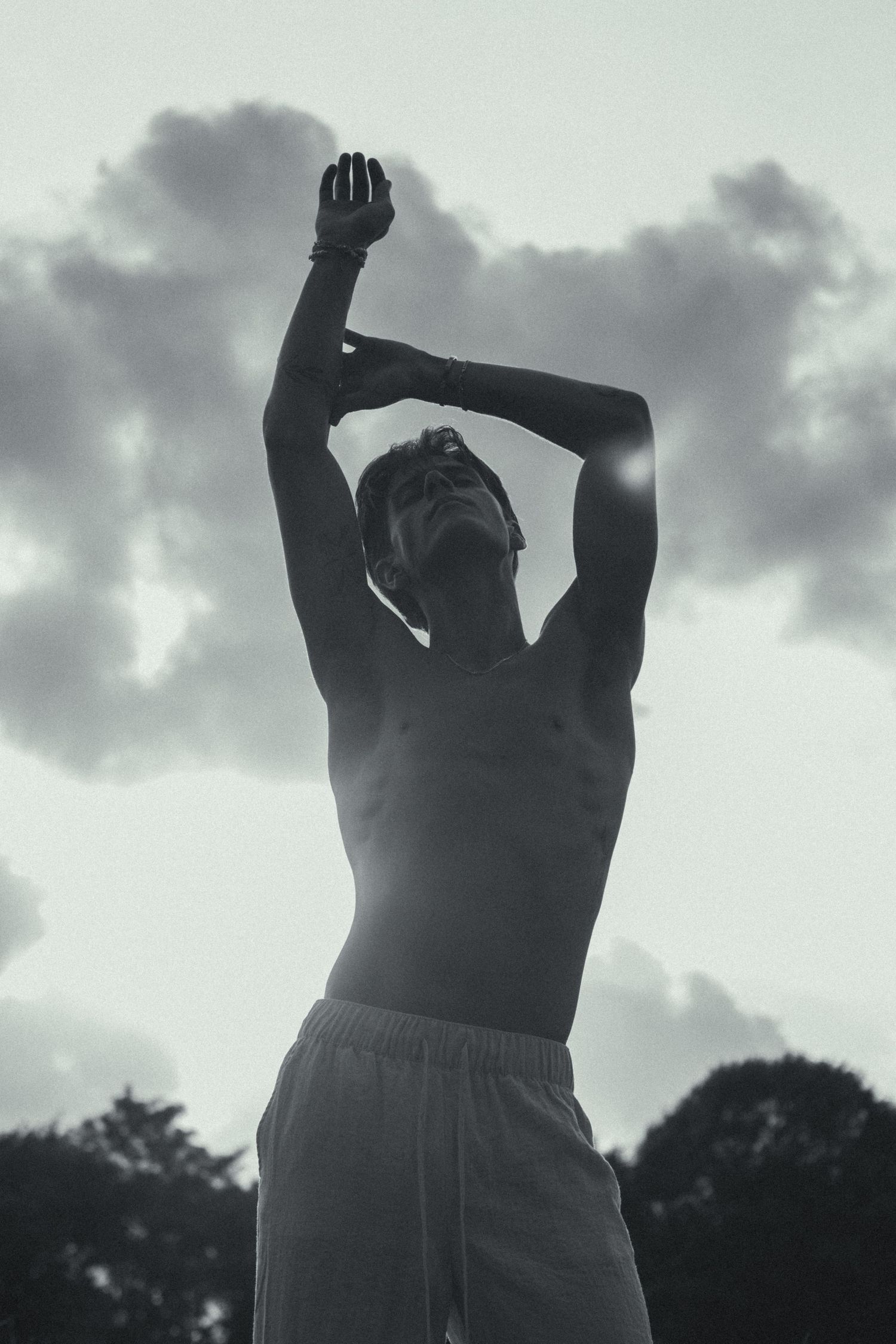 A man with his arms stretched towards the sky.