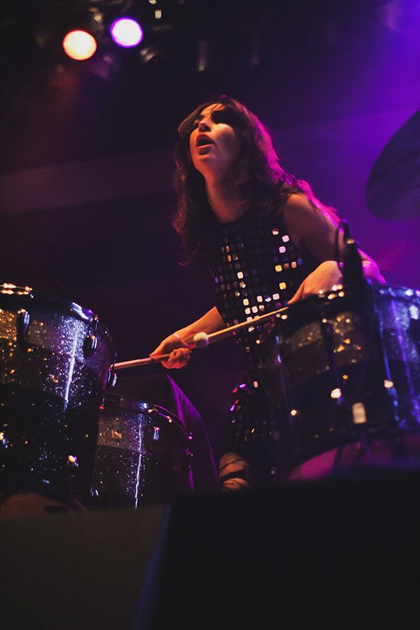 A woman playing drums