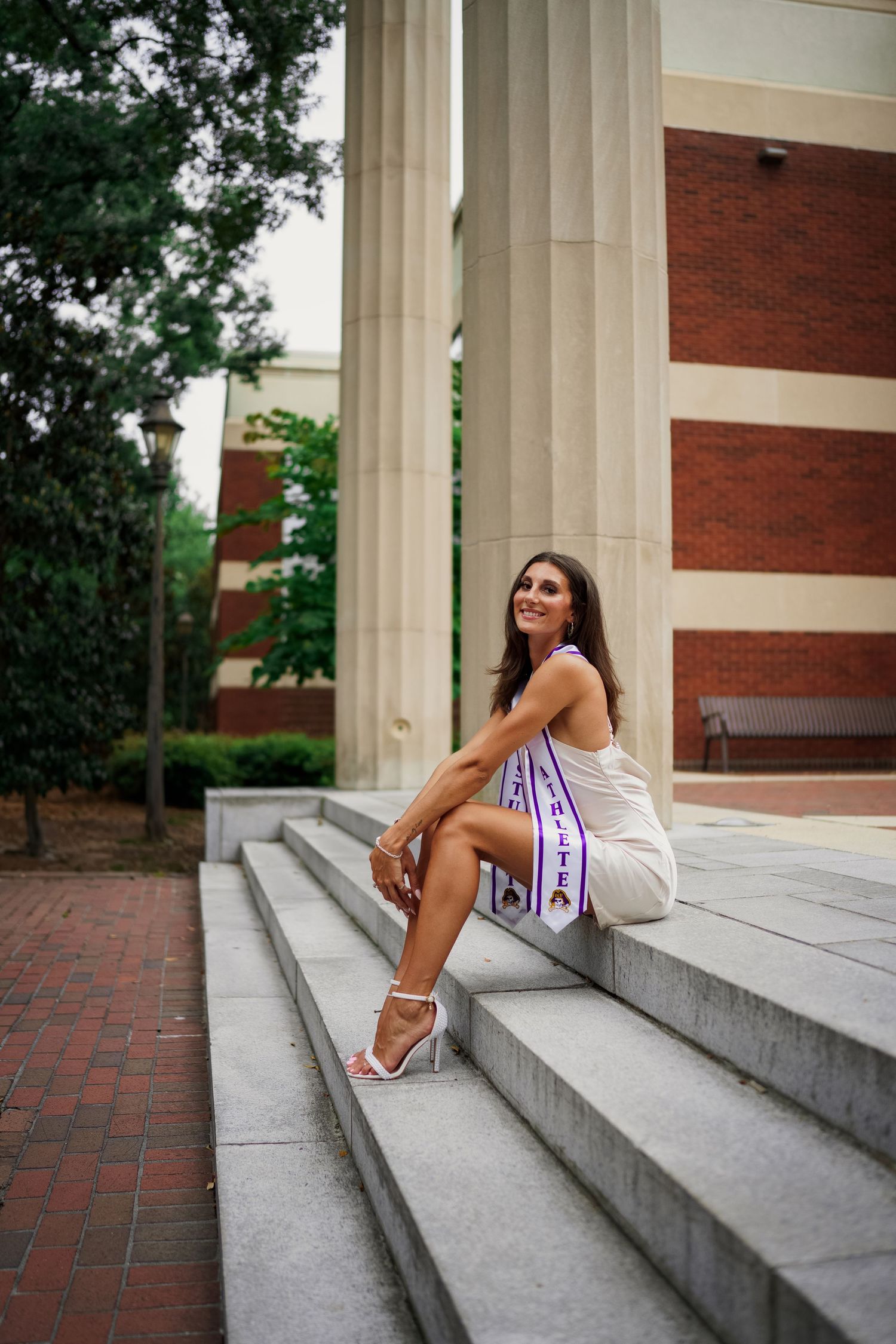 ECU Graduate poses on East carolina university's campus for the best ECU grad photos  by Joan Avilez ECU grad photographer at joyner library