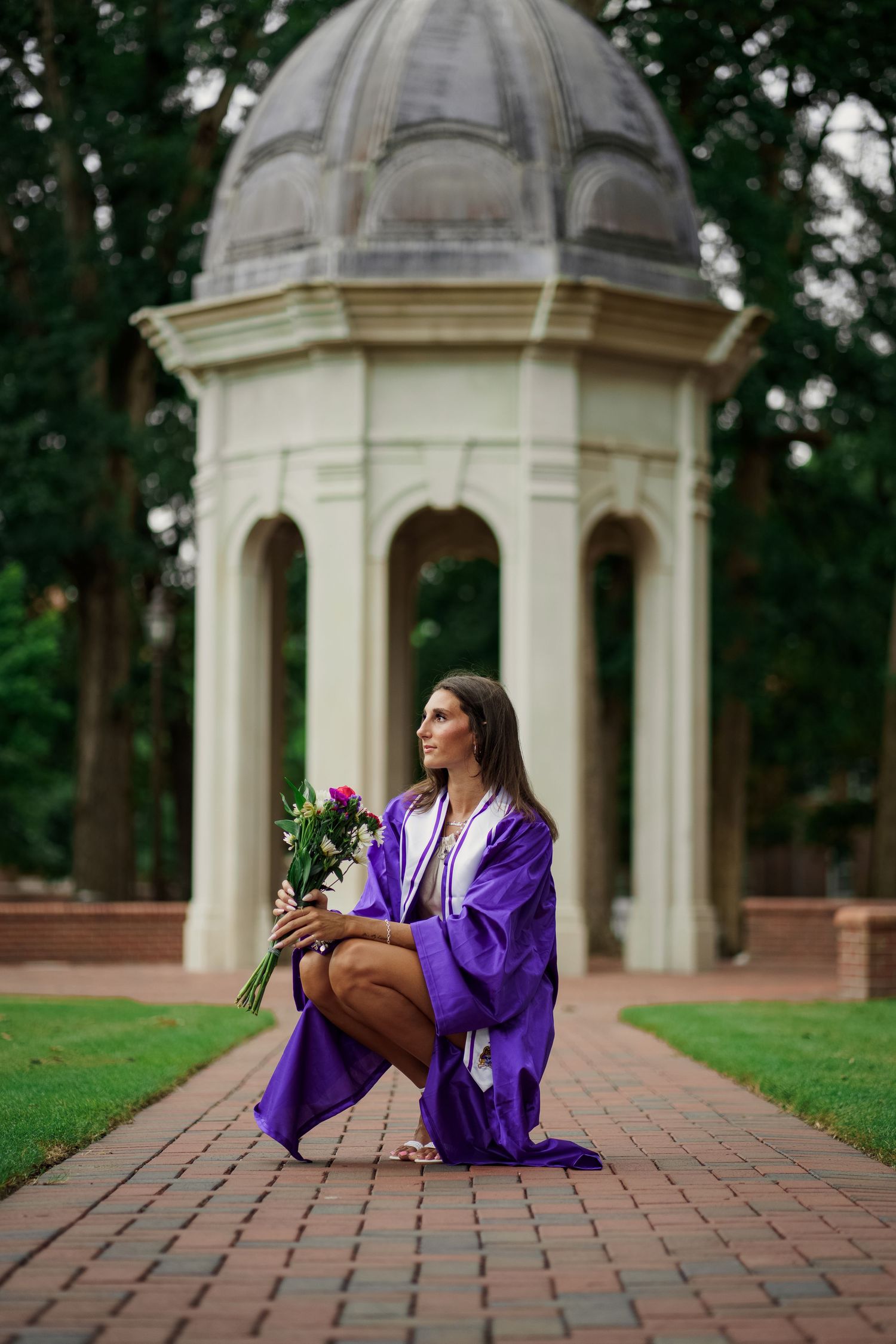 ECU Graduate poses on East carolina university's campus for the best ECU grad photos  by Joan Avilez ECU grad photographer at the cupola