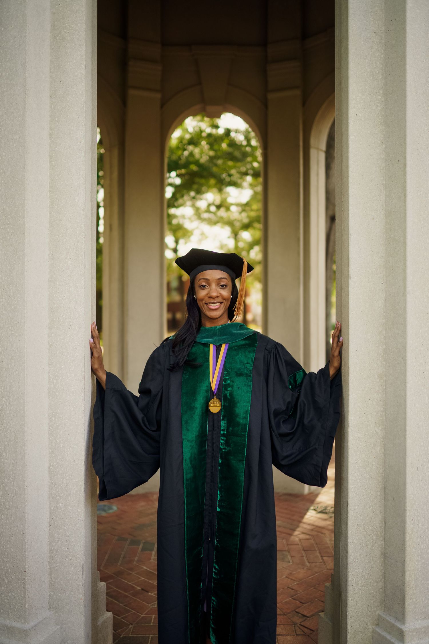 ECU Doctorate Graduate poses on East carolina university's campus for the best ECU grad photos by Joan Avilez Photography. At the ECU Cupola