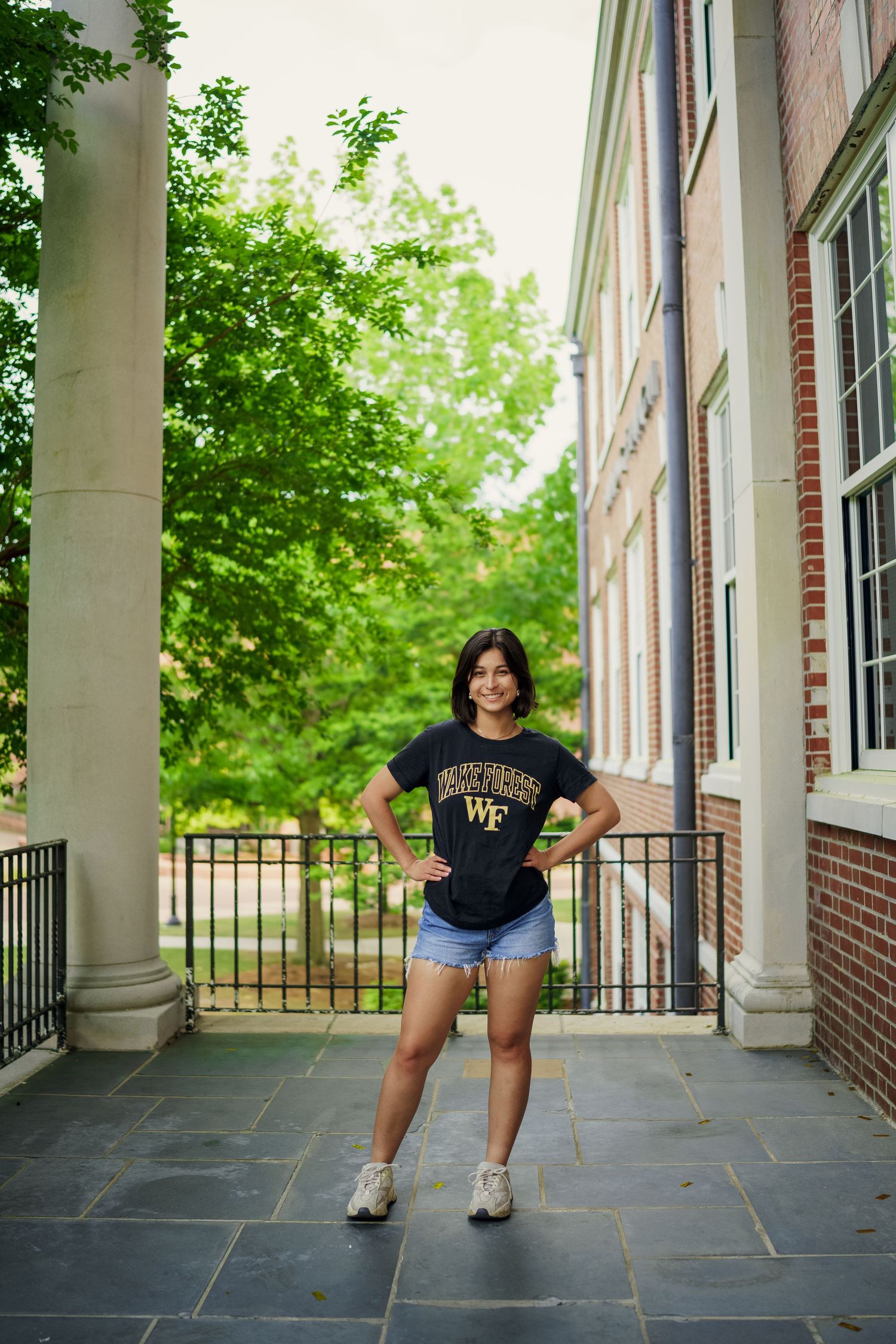ECU Graduate poses on East carolina university's campus for the best ECU grad photos  by Joan Avilez ECU grad photographer