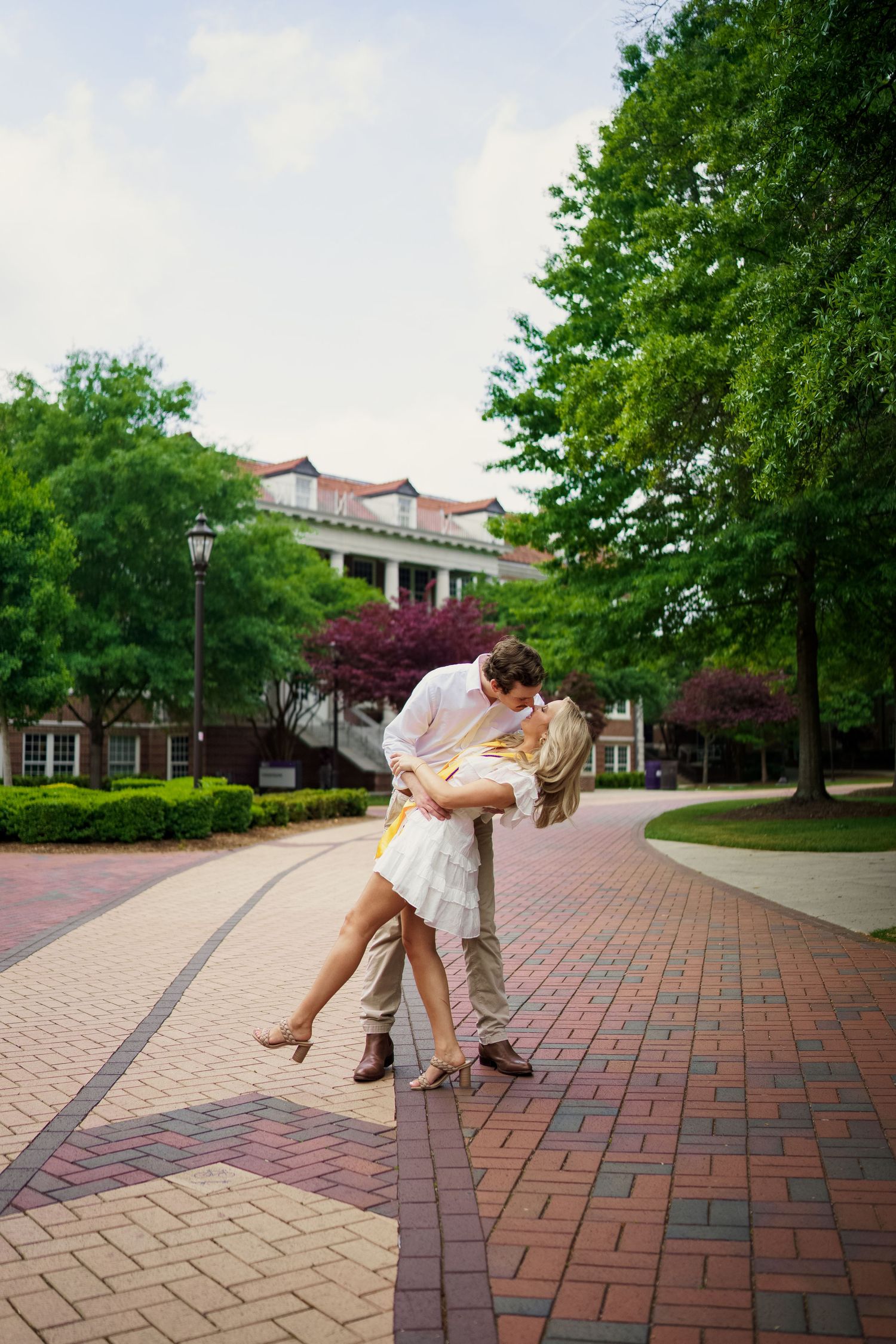 ECU Graduate poses on East carolina university's campus for the best ECU grad photos by Joan Avilez Photography