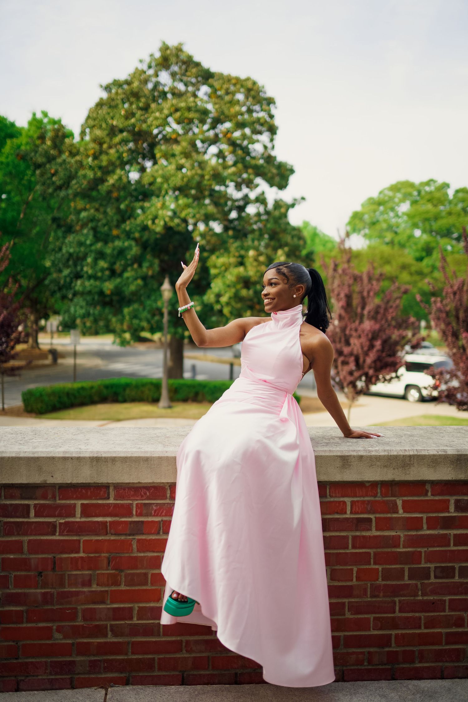 ECU Graduate poses on East carolina university's campus for the best ECU grad photos by Joan Avilez Photography