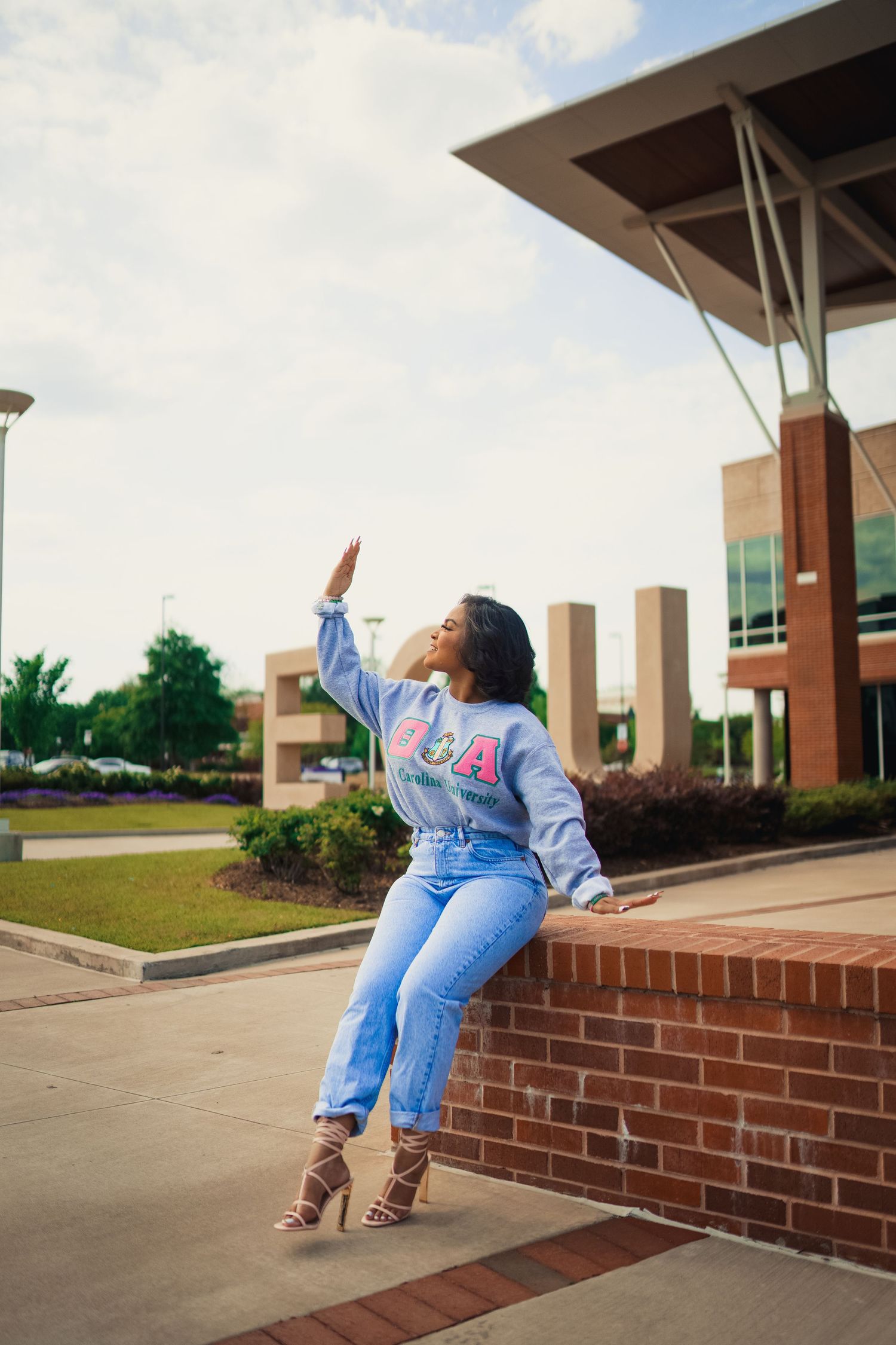 East Carolina University senior posing in Front of the new ECU student center.