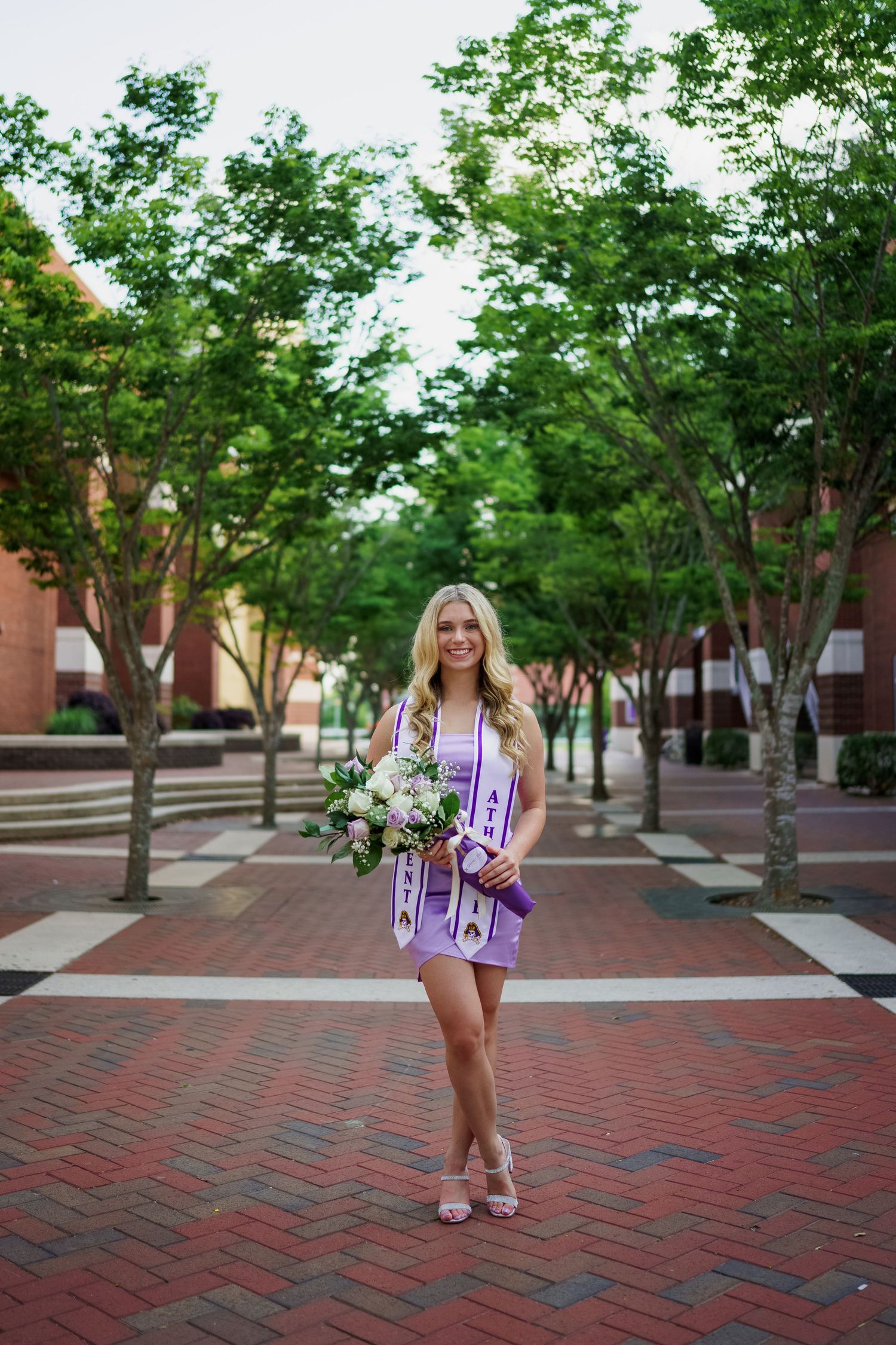 ECU Graduate poses on East carolina university's campus for the best ECU grad photos  by Joan Avilez ECU grad photographer at joyner