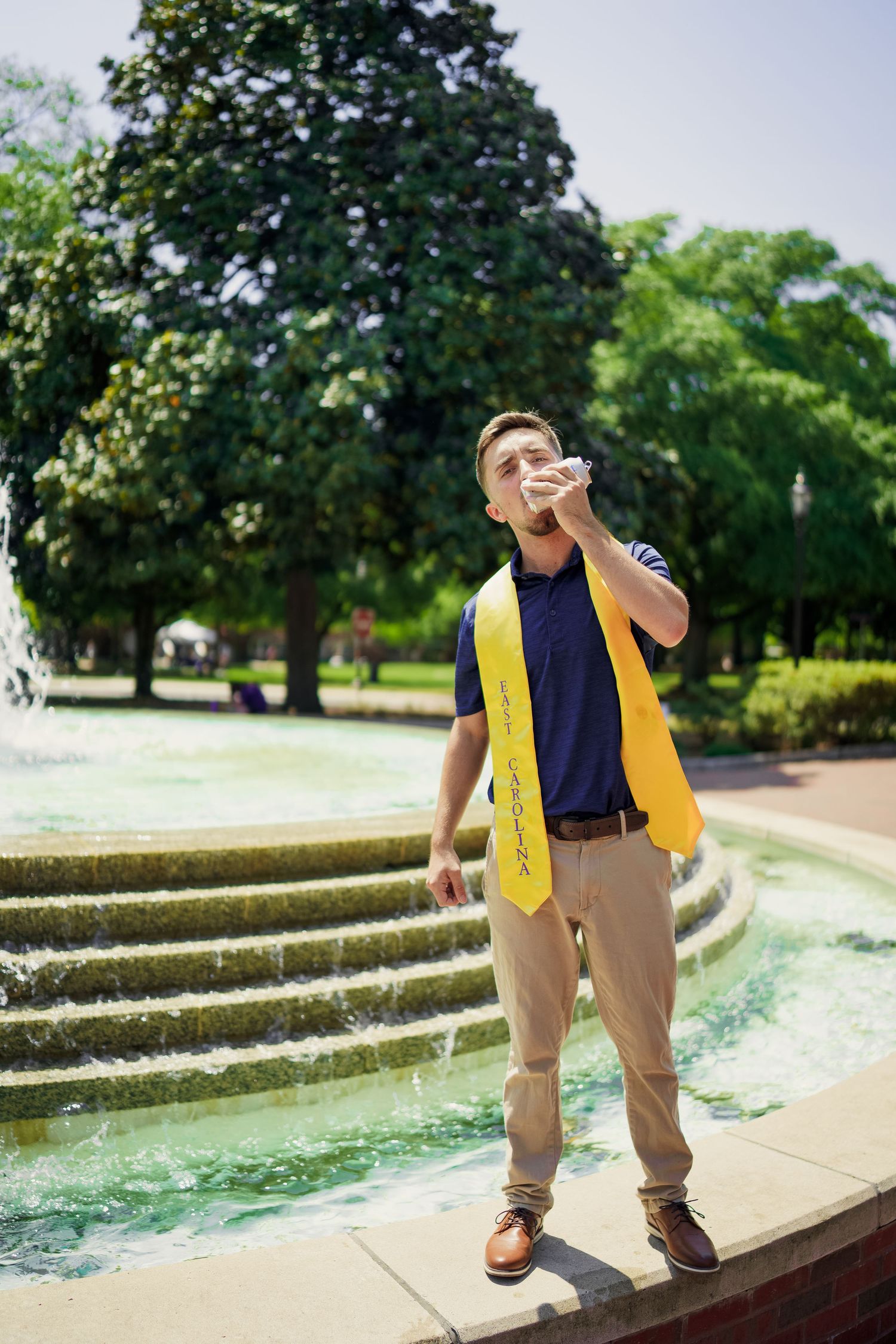 ECU Graduate poses on East carolina university's campus for the best ECU grad photos  by Joan Avilez ECU grad photographer