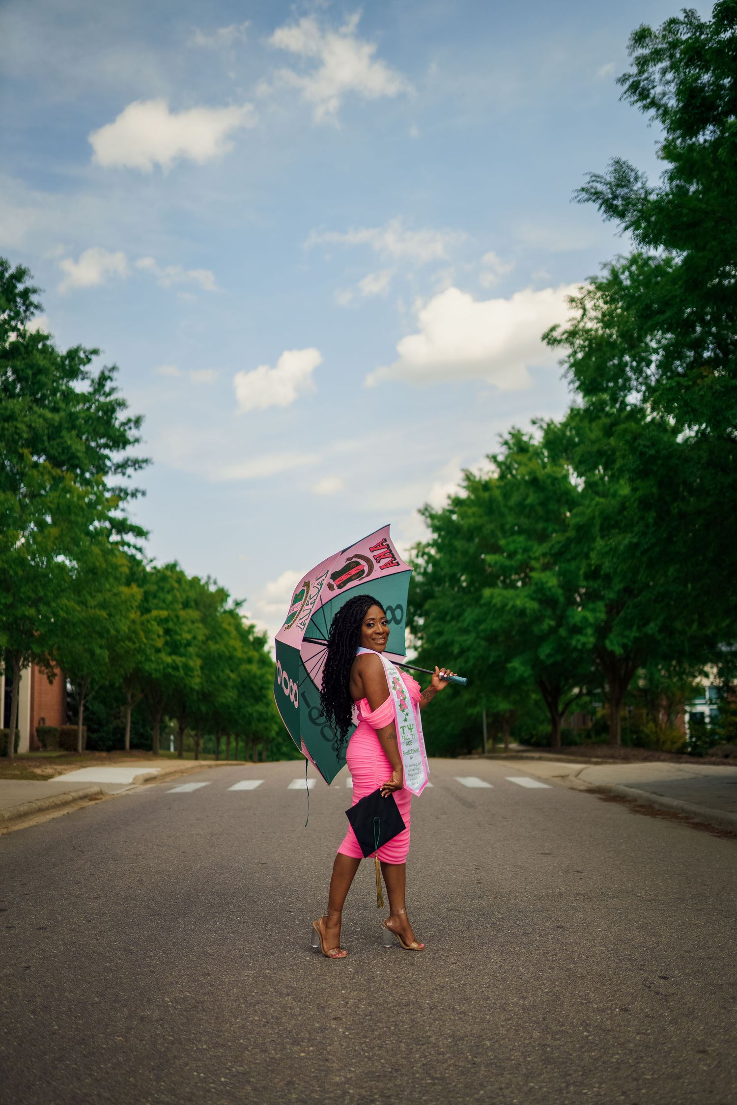 Methodist Graduate poses on Methodist university's campus for the best grad photos by Joan Avilez Photography