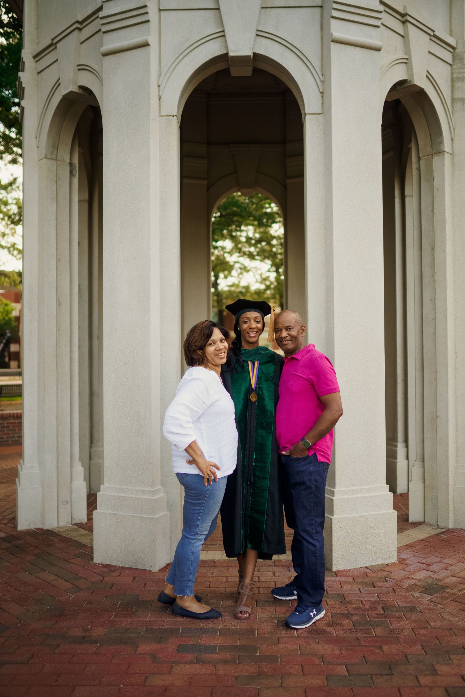 ECU Doctorate Graduate poses on East carolina university's campus for the best ECU grad photos by Joan Avilez Photography. At the ECU Cupola