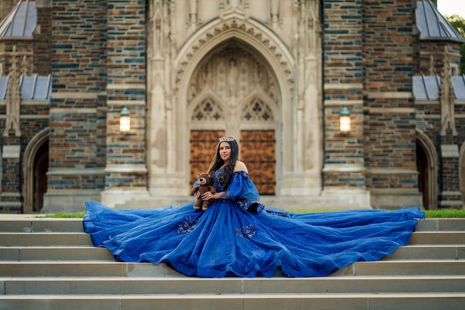 Elegant blue dress with full skirt twirls on cathedral steps creating dramatic circular motion.