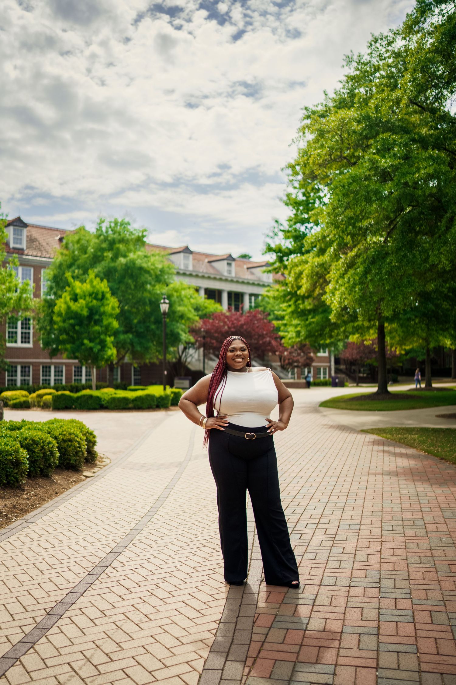 Ecu Graduate poses on East carolina university's campus for the best ECU grad photos by Joan Avilez Photography