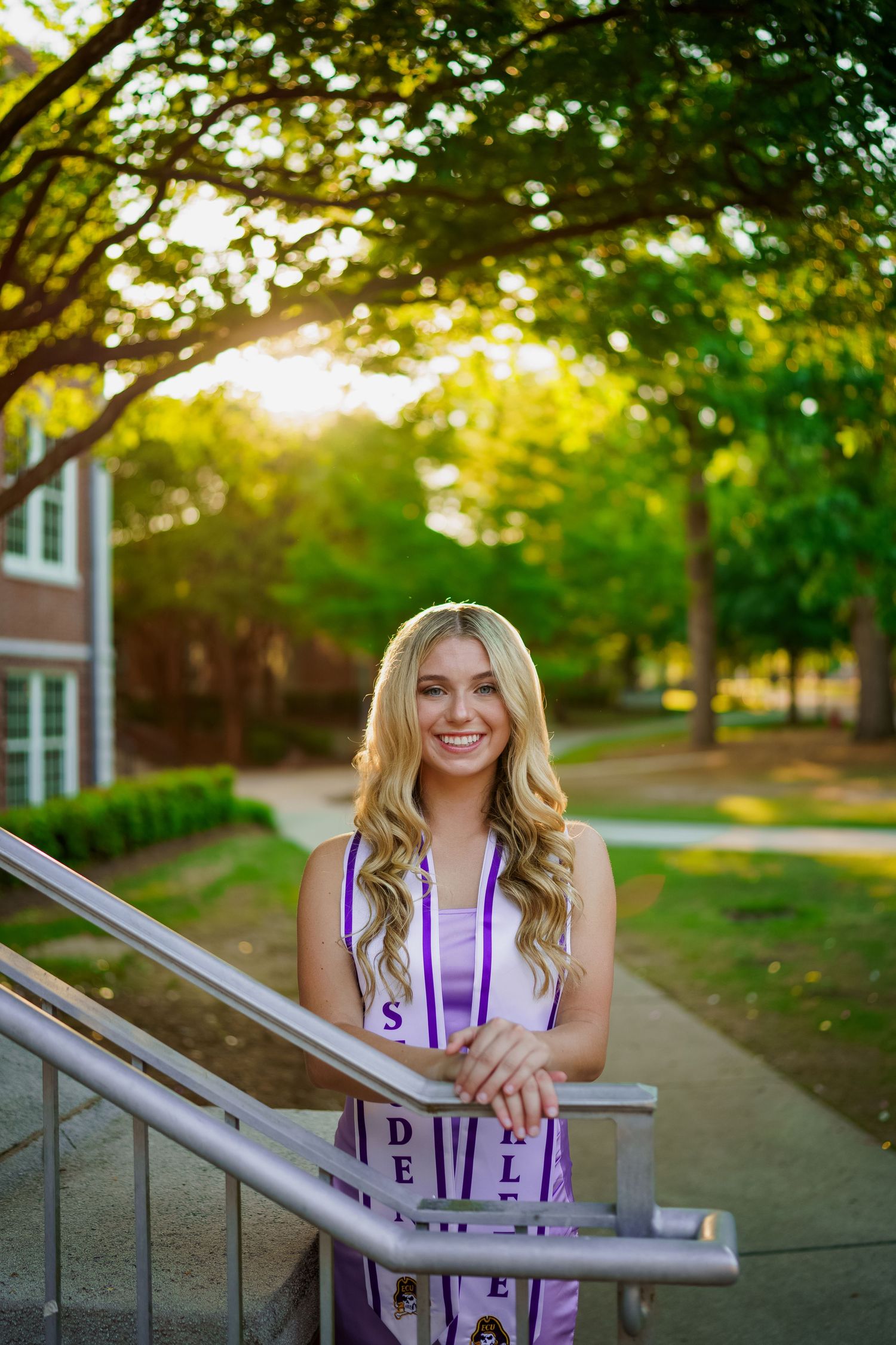 ECU Graduate poses on East carolina university's campus for the best ECU grad photos  by Joan Avilez ECU grad photographer at bate