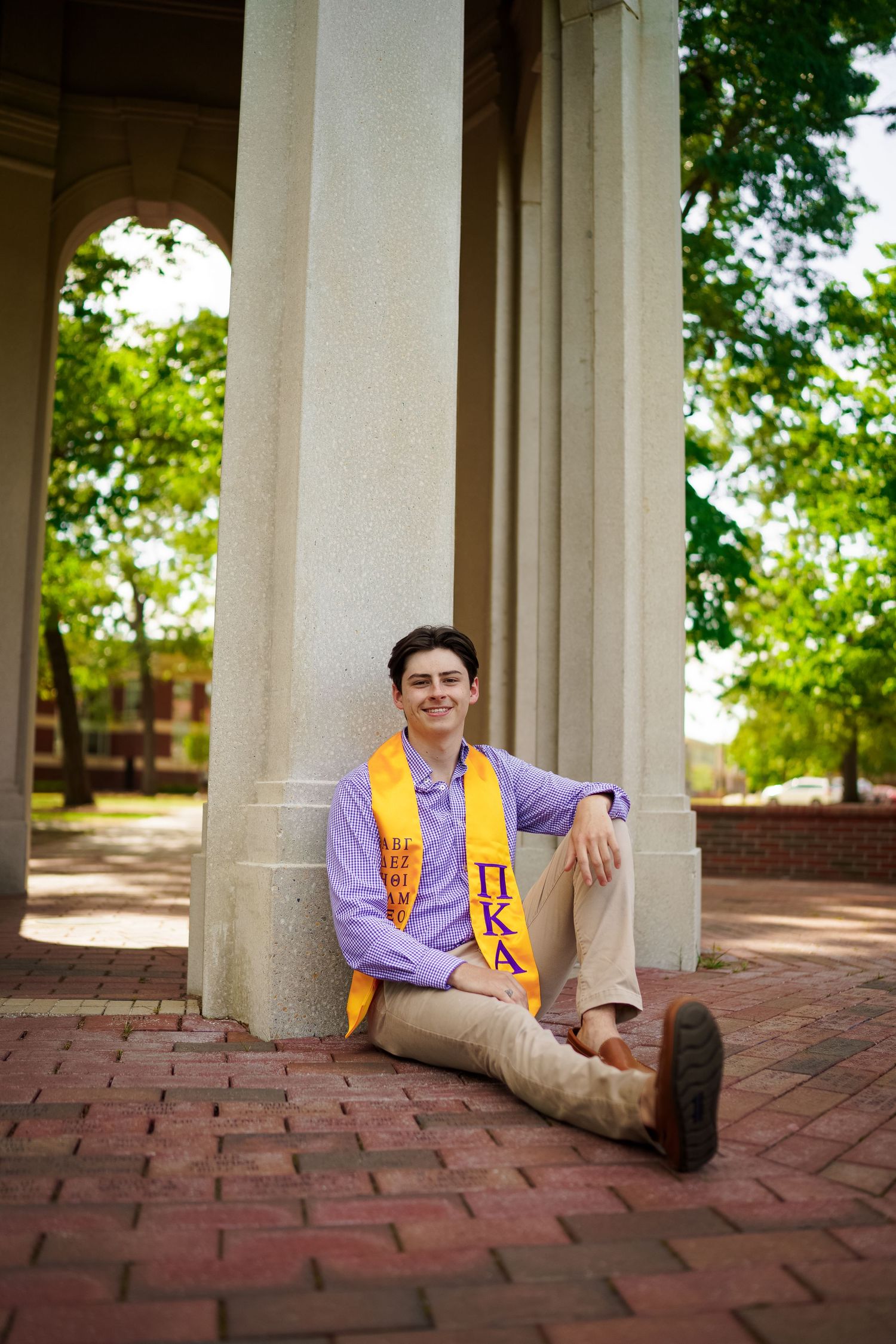 ECU Graduate poses on East carolina university's campus for the best ECU grad photos by Joan Avilez Photography at the cupola