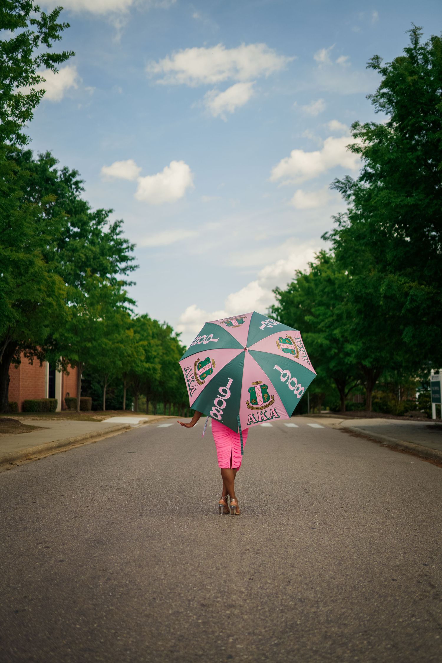 Methodist Graduate poses on Methodist university's campus for the best grad photos by Joan Avilez Photography