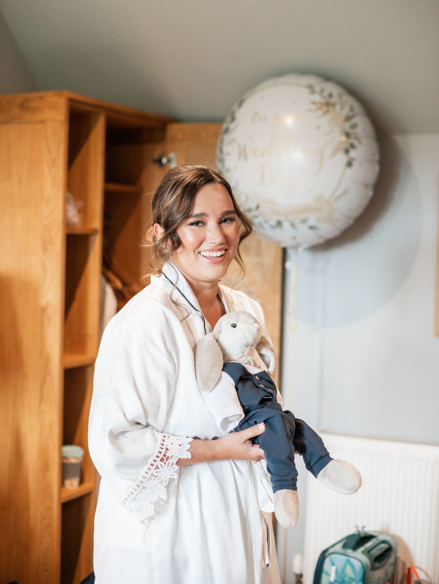 A morning wedding preparation scene with a white robe and decorative balloon.