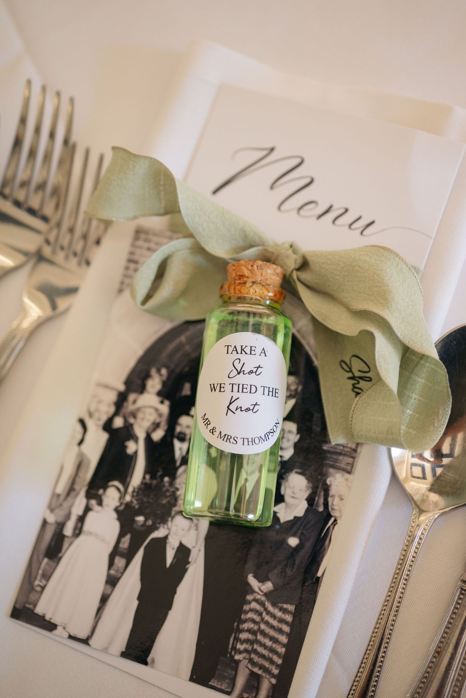 Black and white vintage photos displayed with small decorative bottles and eucalyptus leaves.