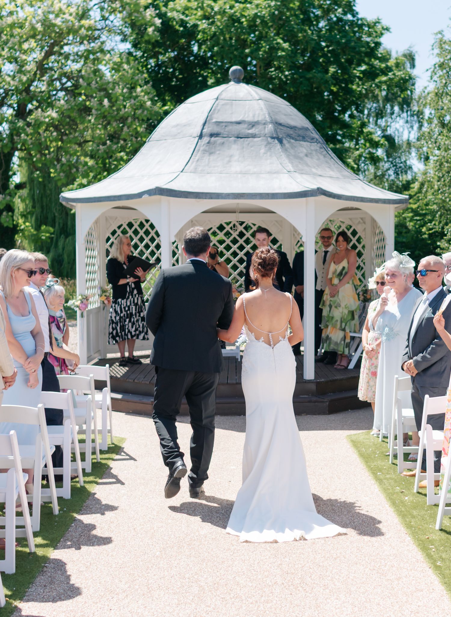Wedding ceremony sequence showing guests under elegant white gazebos in a garden setting.