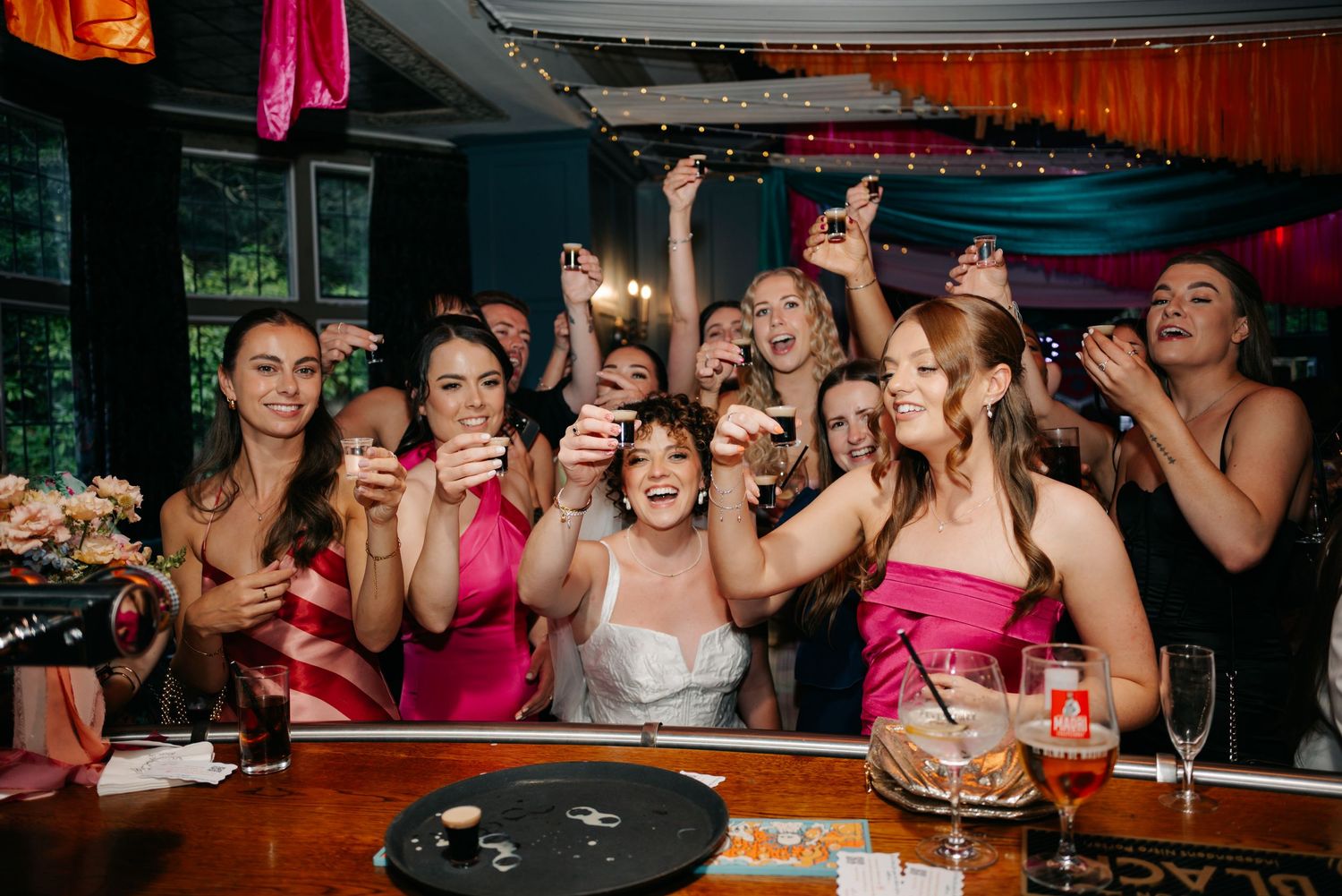 Lively wedding reception dance floor scene with festive lighting.