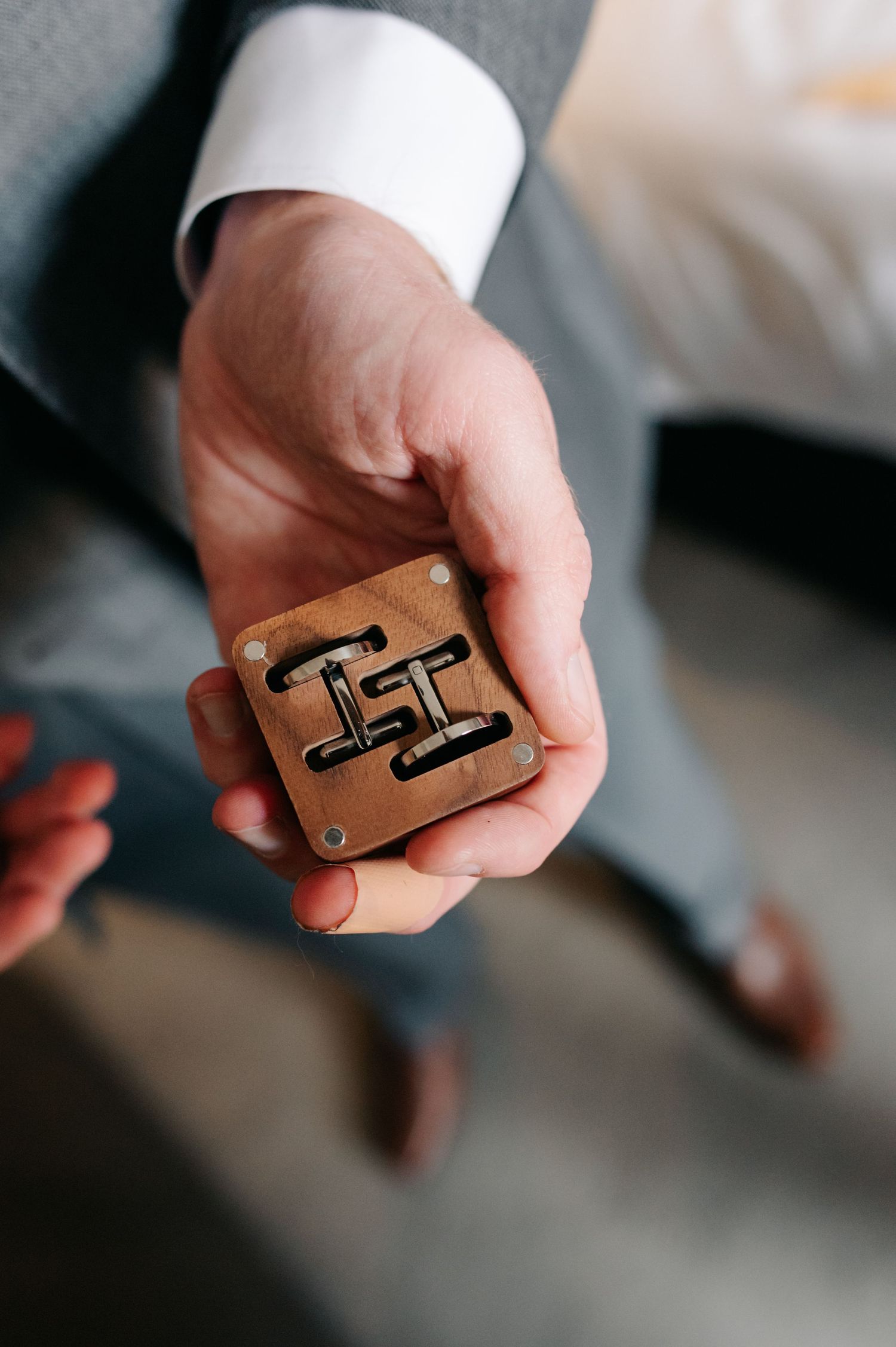 Close-up sequence showing hands holding a wooden puzzle piece at different angles.