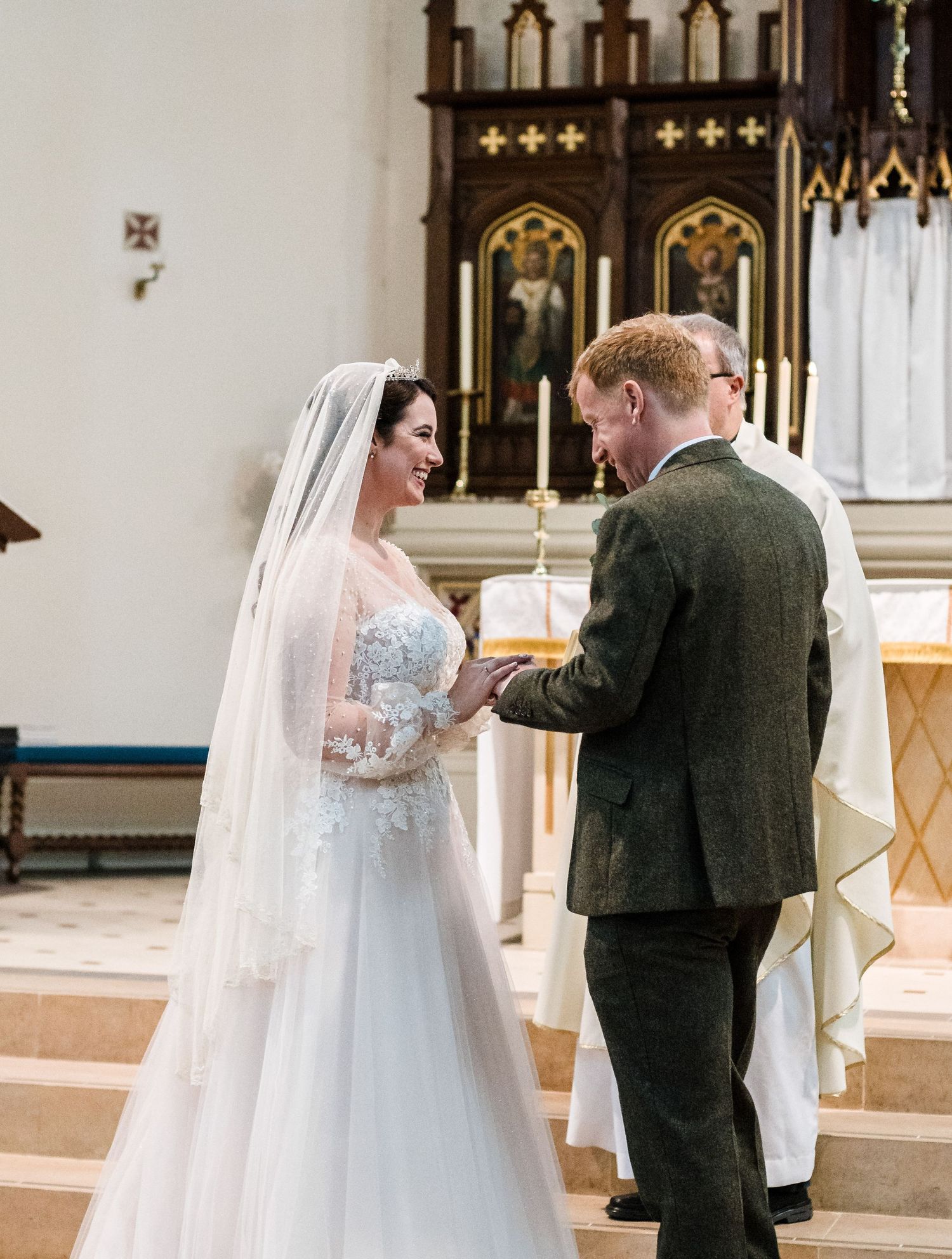 Romantic wedding ceremony moment at the altar in a traditional church setting.