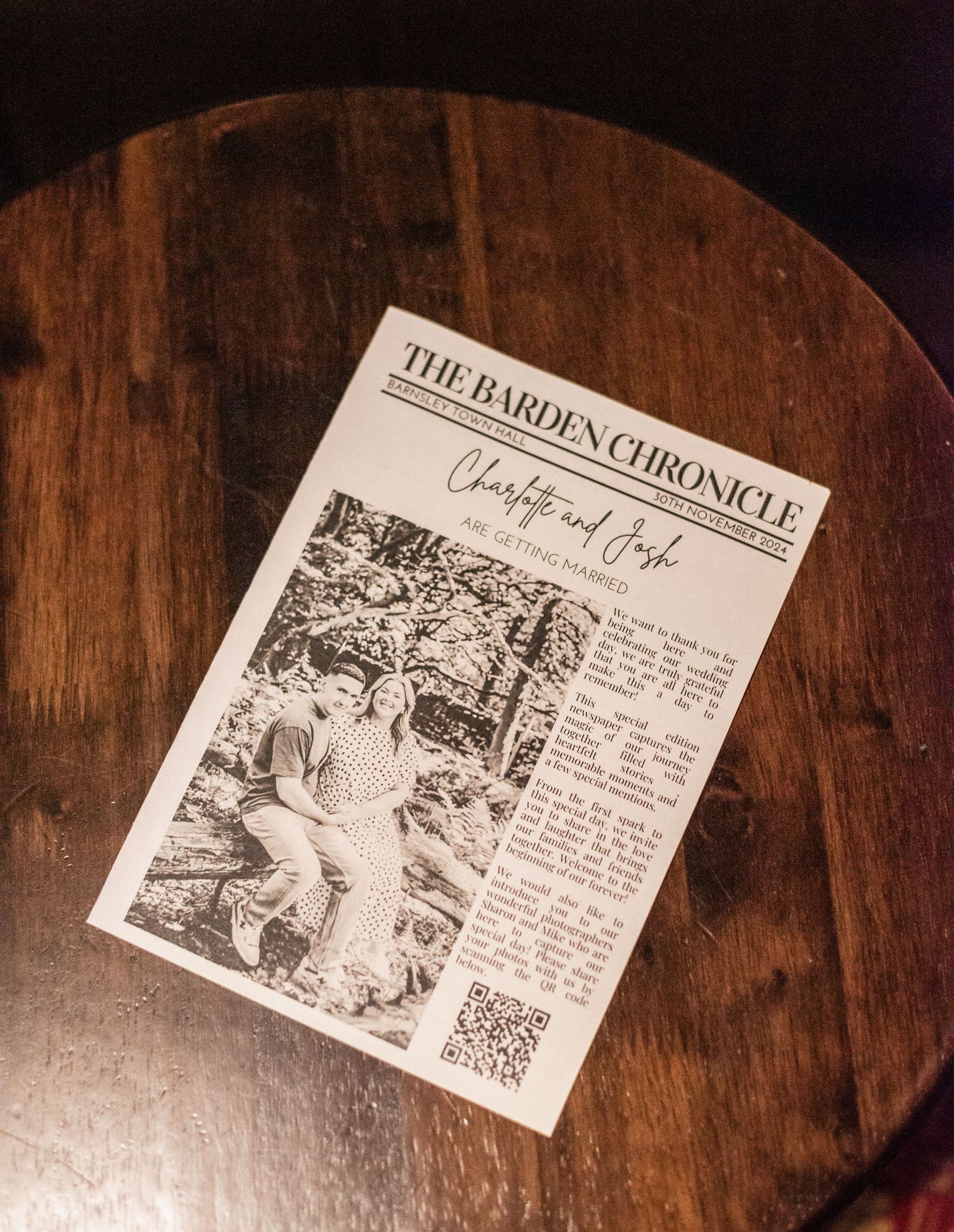 A newspaper titled 'The Barden Chronicle' lies on a dark wooden table surface.