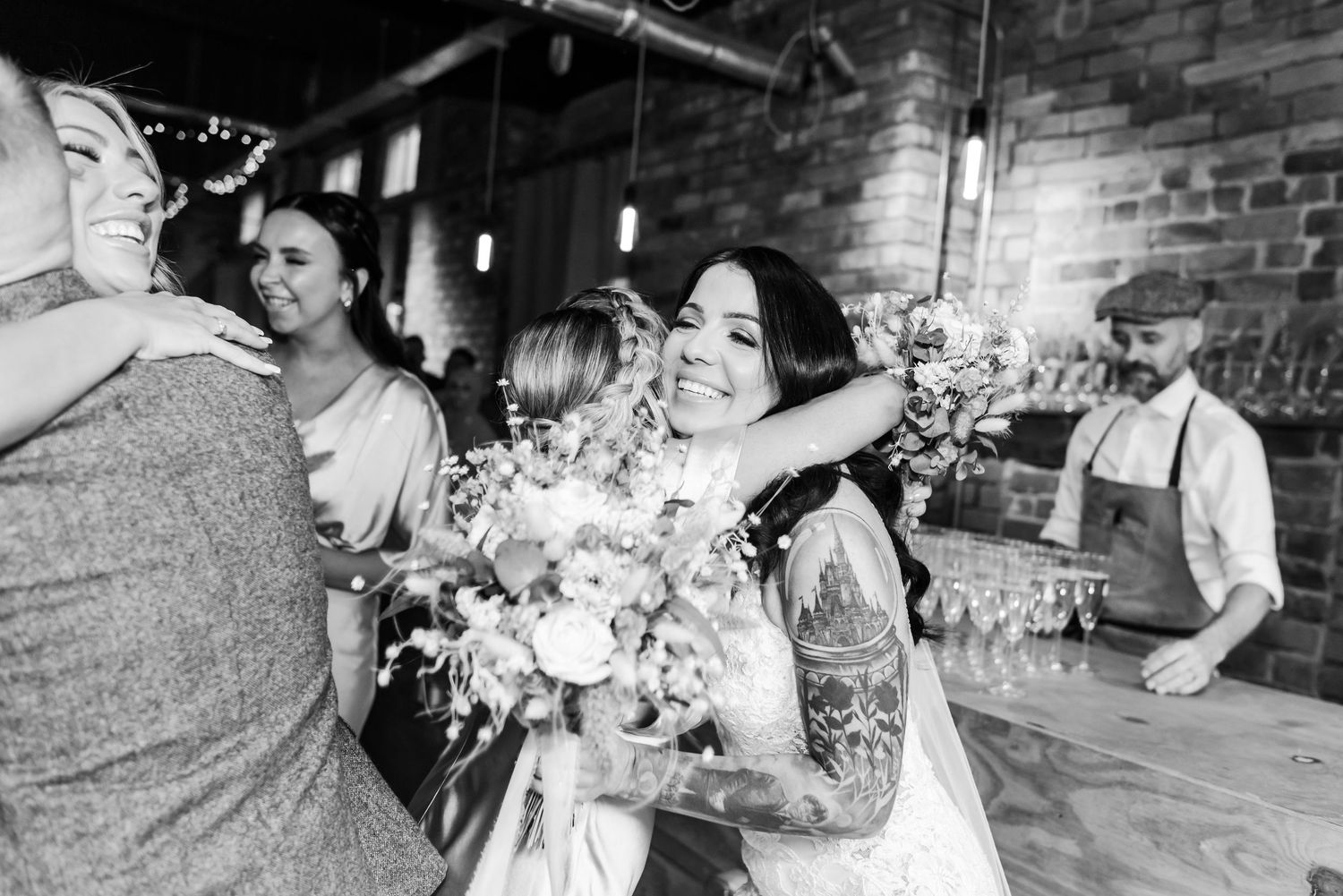 Black and white wedding photos showing couples dancing and celebrating at a joyful reception celebration.