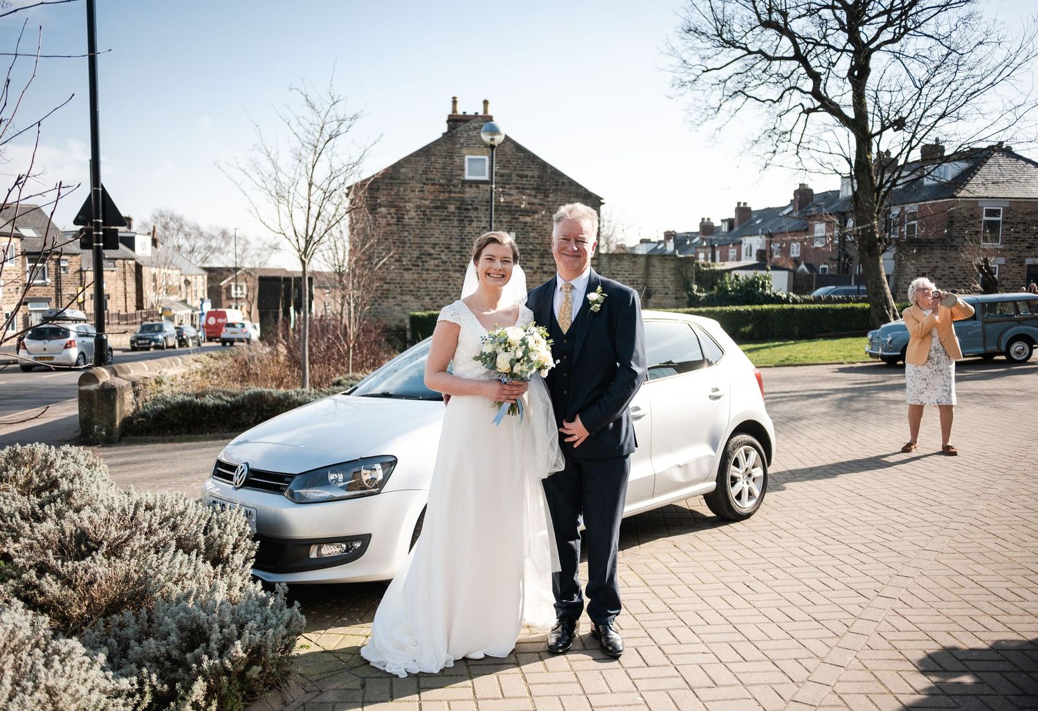 A series of outdoor wedding photos showing a couple walking along a stone pathway on their special day.