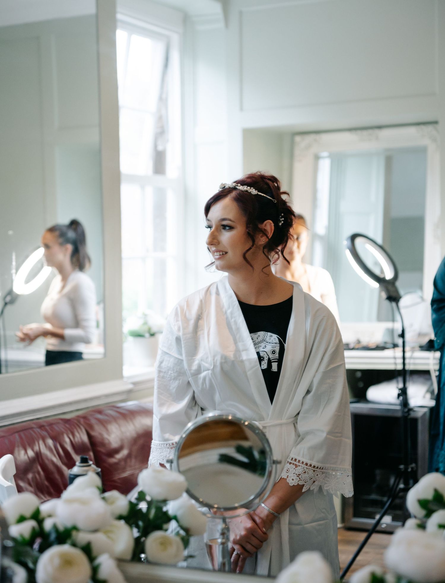 A series of getting ready photos showing someone in a white robe preparing for a special occasion in a bright room.