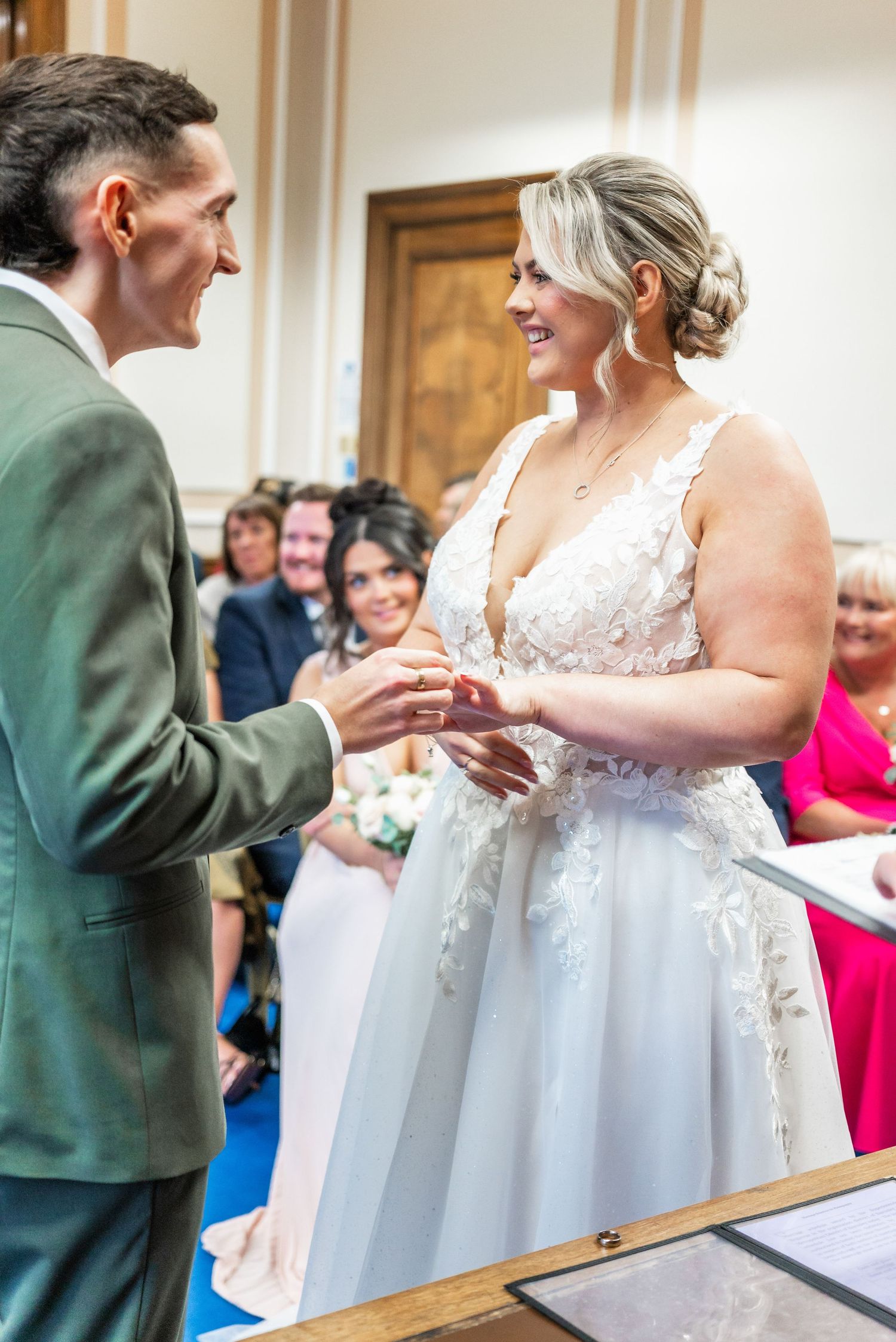 Intimate wedding ceremony moment shared between couple during ring exchange.