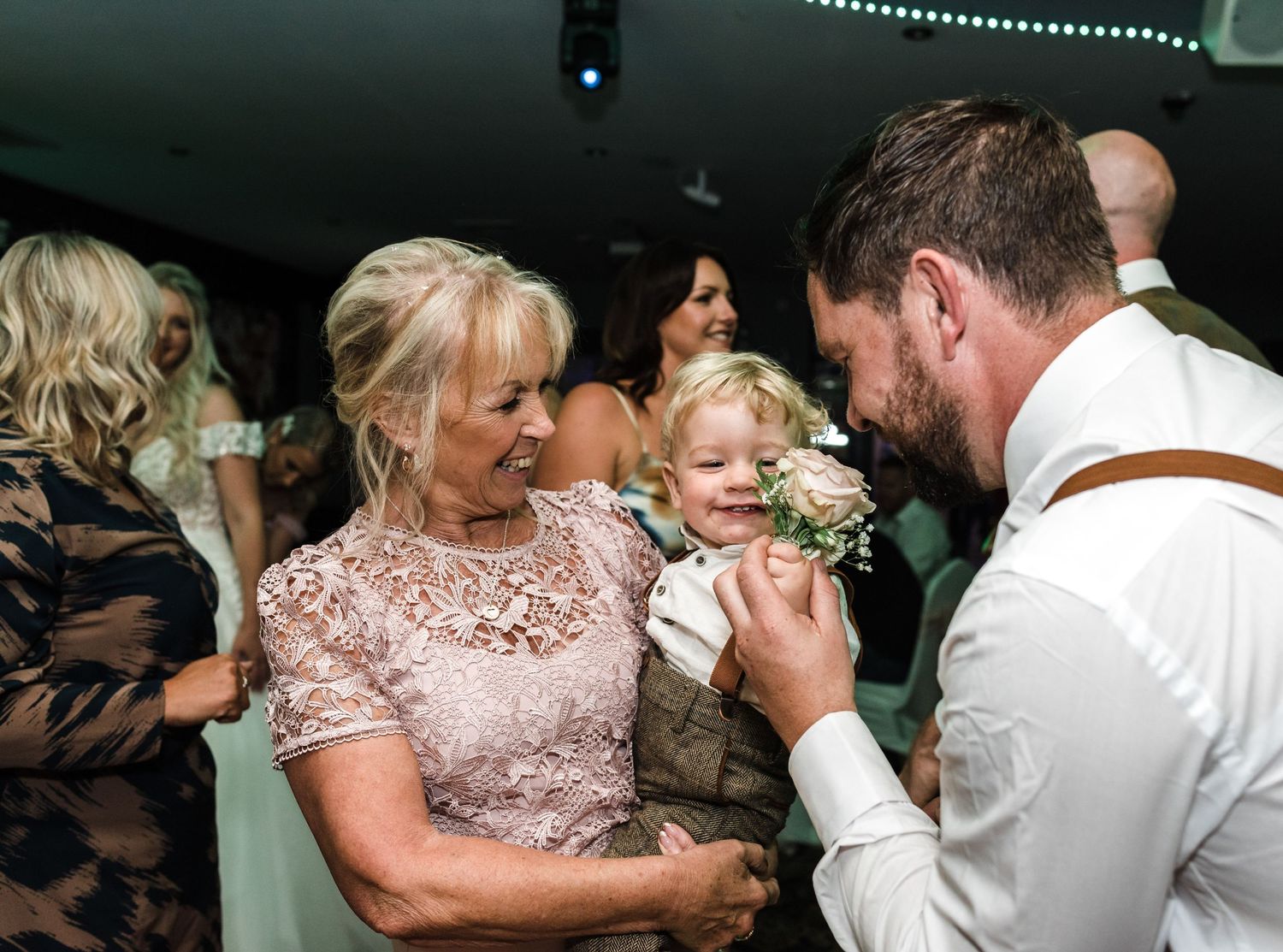 A tender family moment shared during a wedding reception.