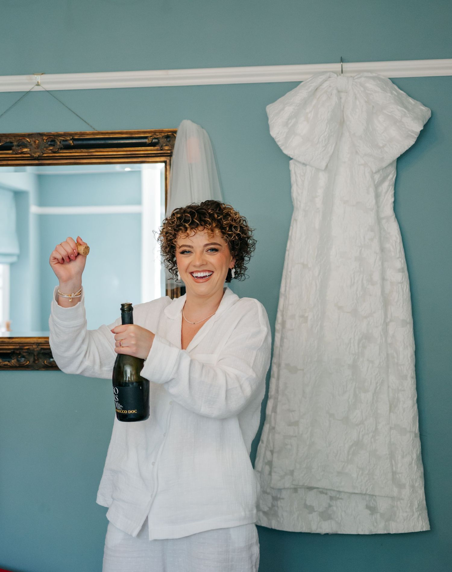 A series of candid moments showing joyful expressions and movement against a teal blue wall.