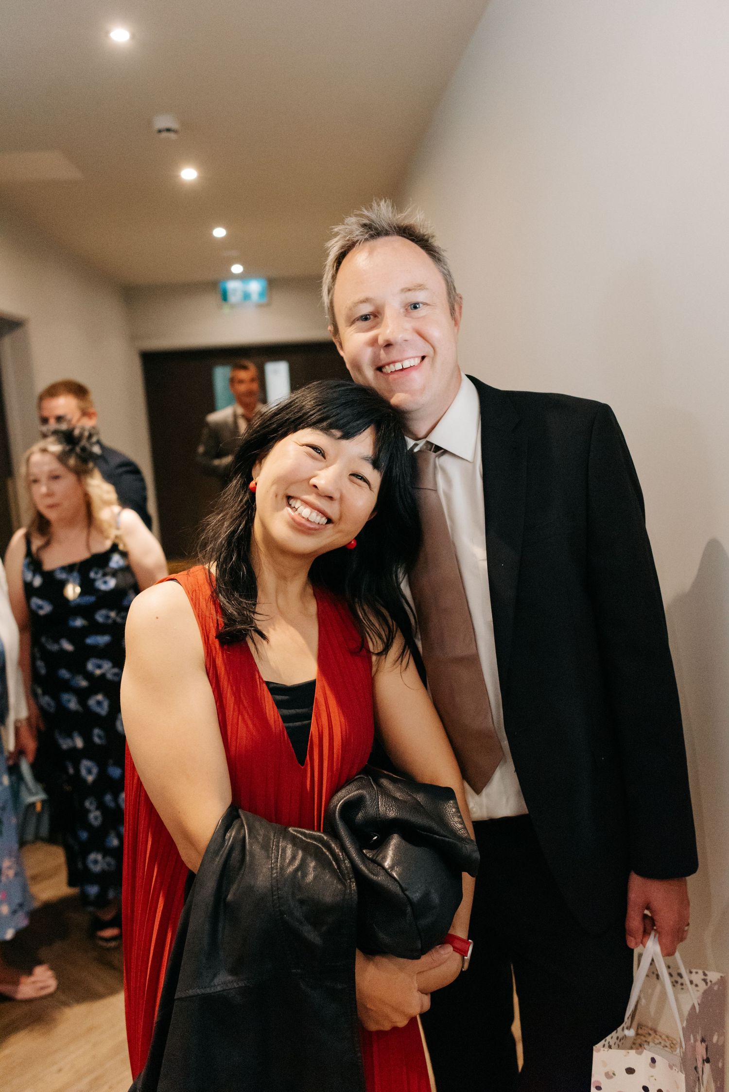A series of candid party photos showing people laughing and socializing at an indoor event.