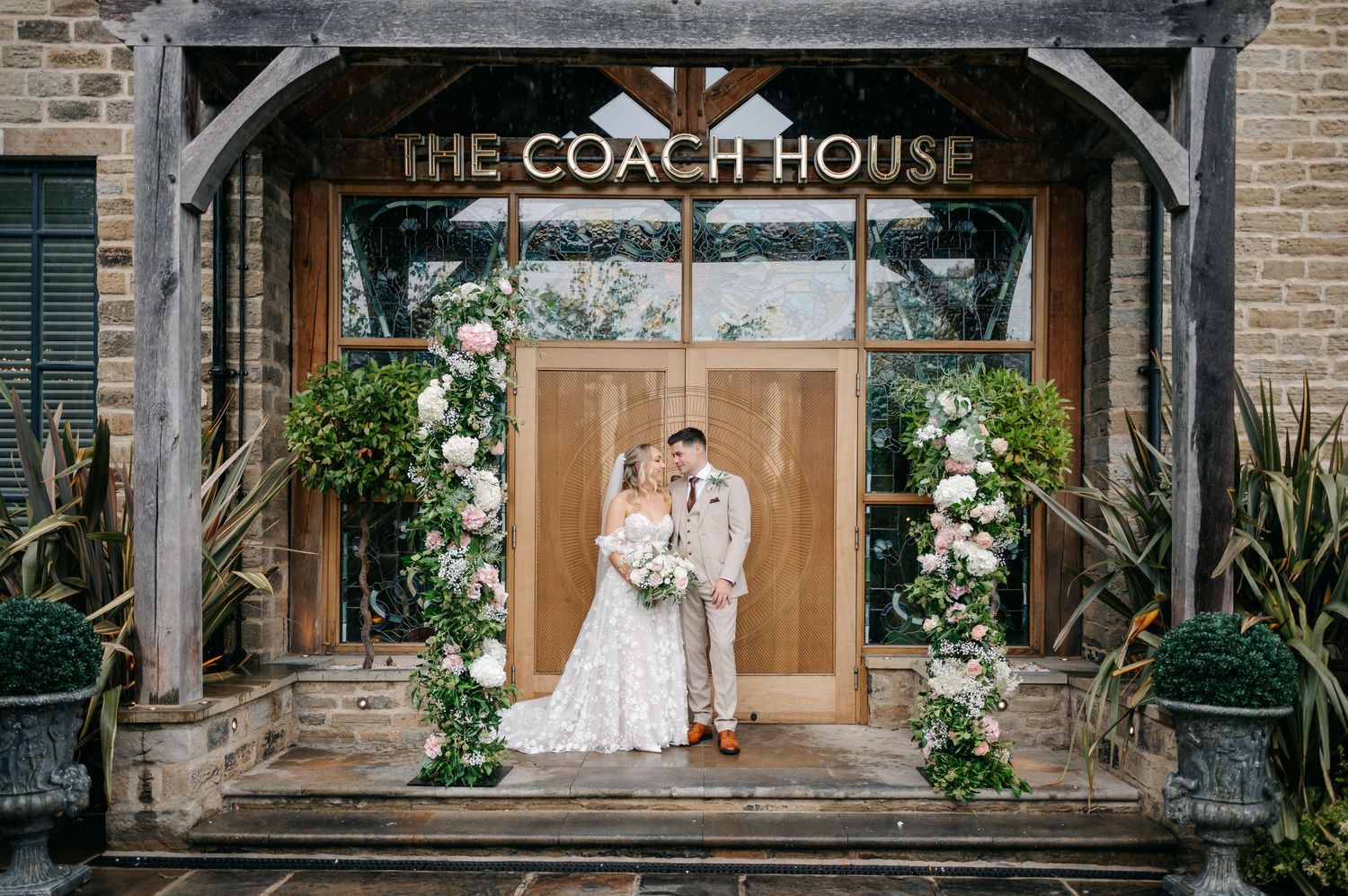 Exterior view of The Coach House wedding venue with brick facade.