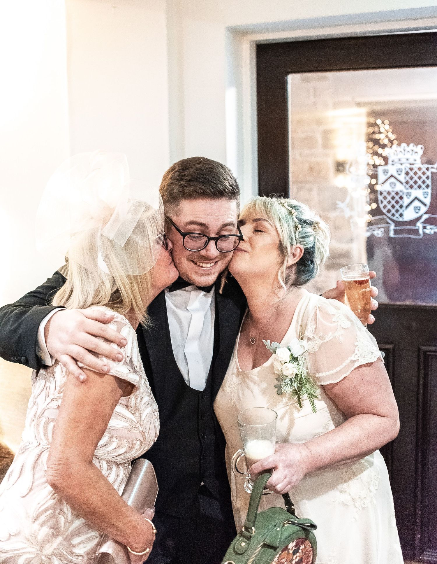 Sweet celebratory moment at a formal event with embraces and affection.